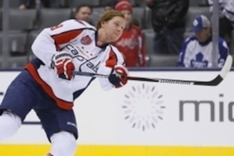 Jan 7, 2015; Toronto, Ontario, CAN; Washington Capitals forward Nicklas Backstrom (19) shoots the puck during the pre game warm up against the Toronto Maple Leafs at the Air Canada Centre. Washington defeated Toronto 6-2. Mandatory Credit: John E. Sokolow