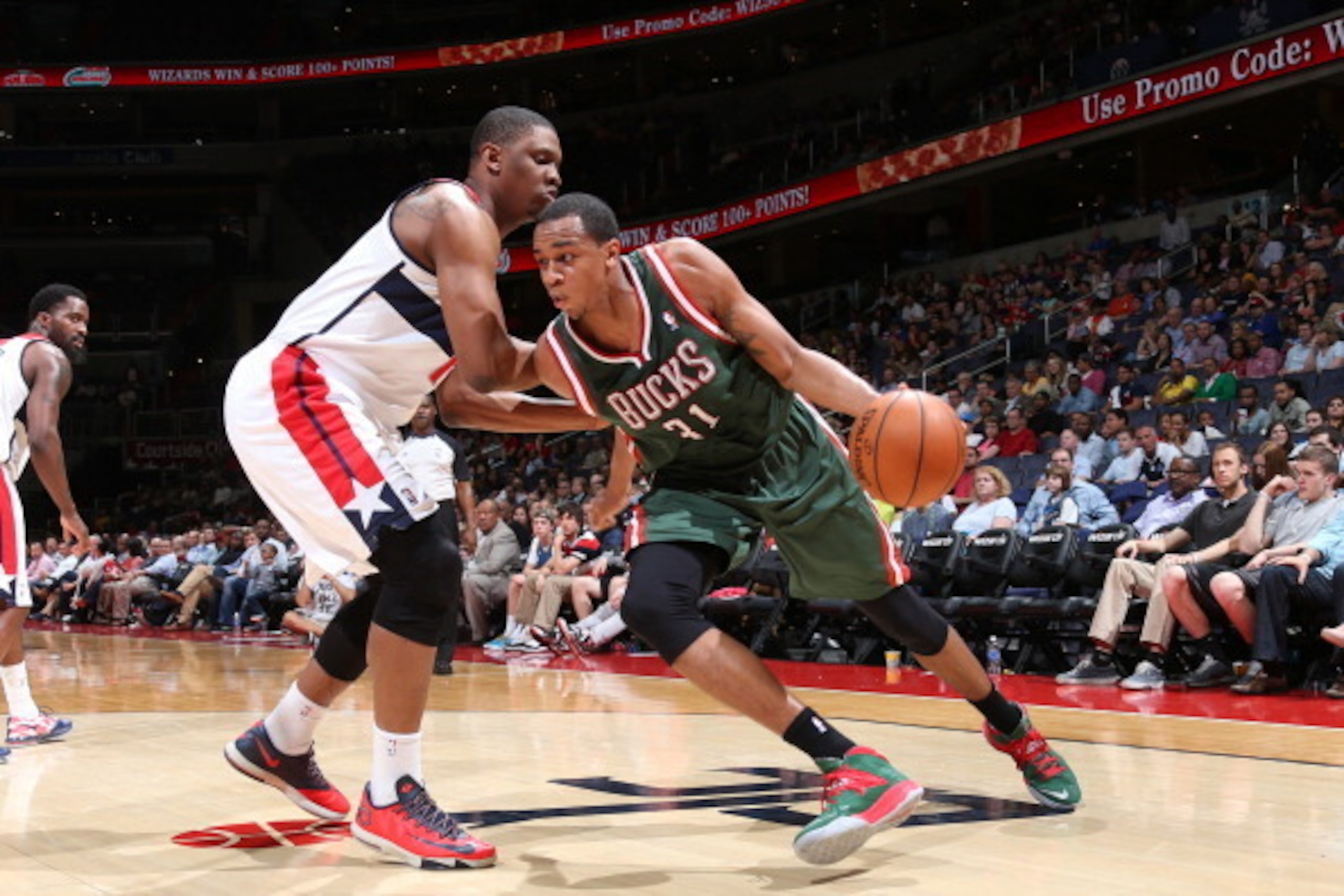 WASHINGTON, DC - APRIL 12: John Henson #31 of the Milwaukee Bucks drives against the Washington Wizards during the game at the Verizon Center on April 12, 2014 in Washington, DC. NOTE TO USER: User expressly acknowledges and agrees that, by downloading an