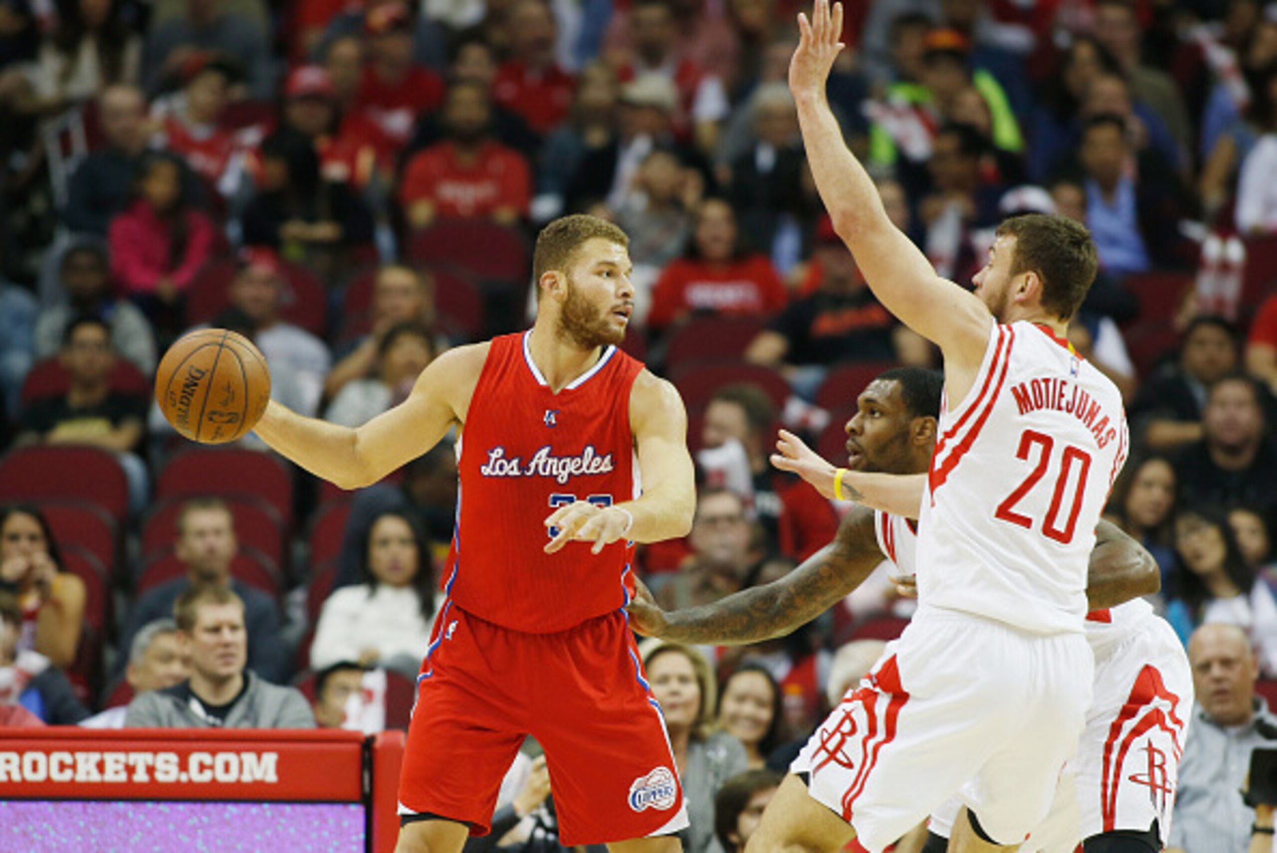 HOUSTON, TX - NOVEMBER 28:  Blake Griffin #32 of the Los Angeles Clippers looks to pass against Donatas Motiejunas #20 and Tarik Black #10 of the Houston Rockets during their gameat the Toyota Center on November 28, 2014 in Houston, Texas.  NOTE TO USER: 
