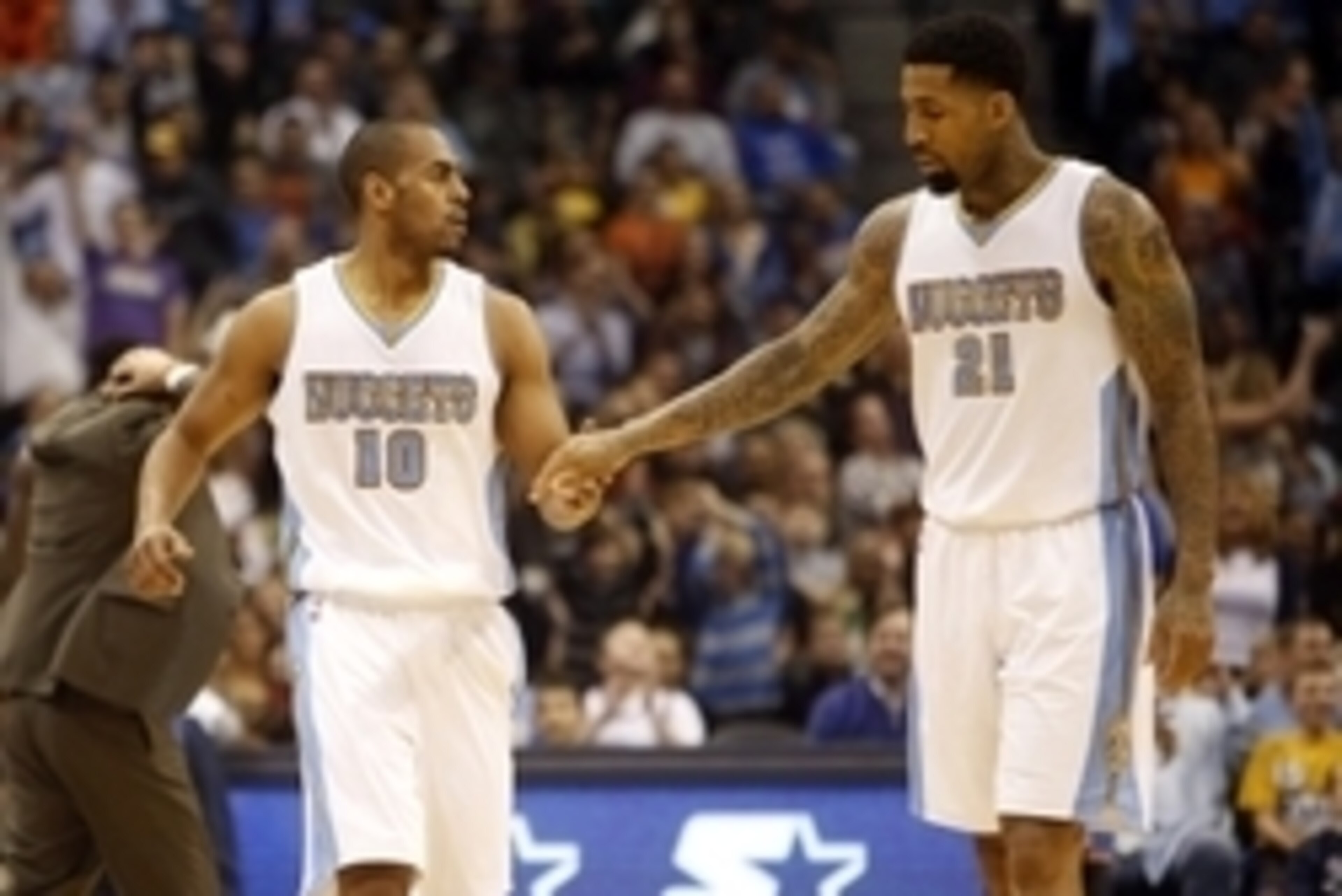 Nov 19, 2014; Denver, CO, USA; Denver Nuggets forward Wilson Chandler (21) and Denver Nuggets guard Arron Afflalo (10) celebrate during the second half against the Oklahoma City Thunder at Pepsi Center. The Nuggets won 107-100.  Mandatory Credit: Chris Hu