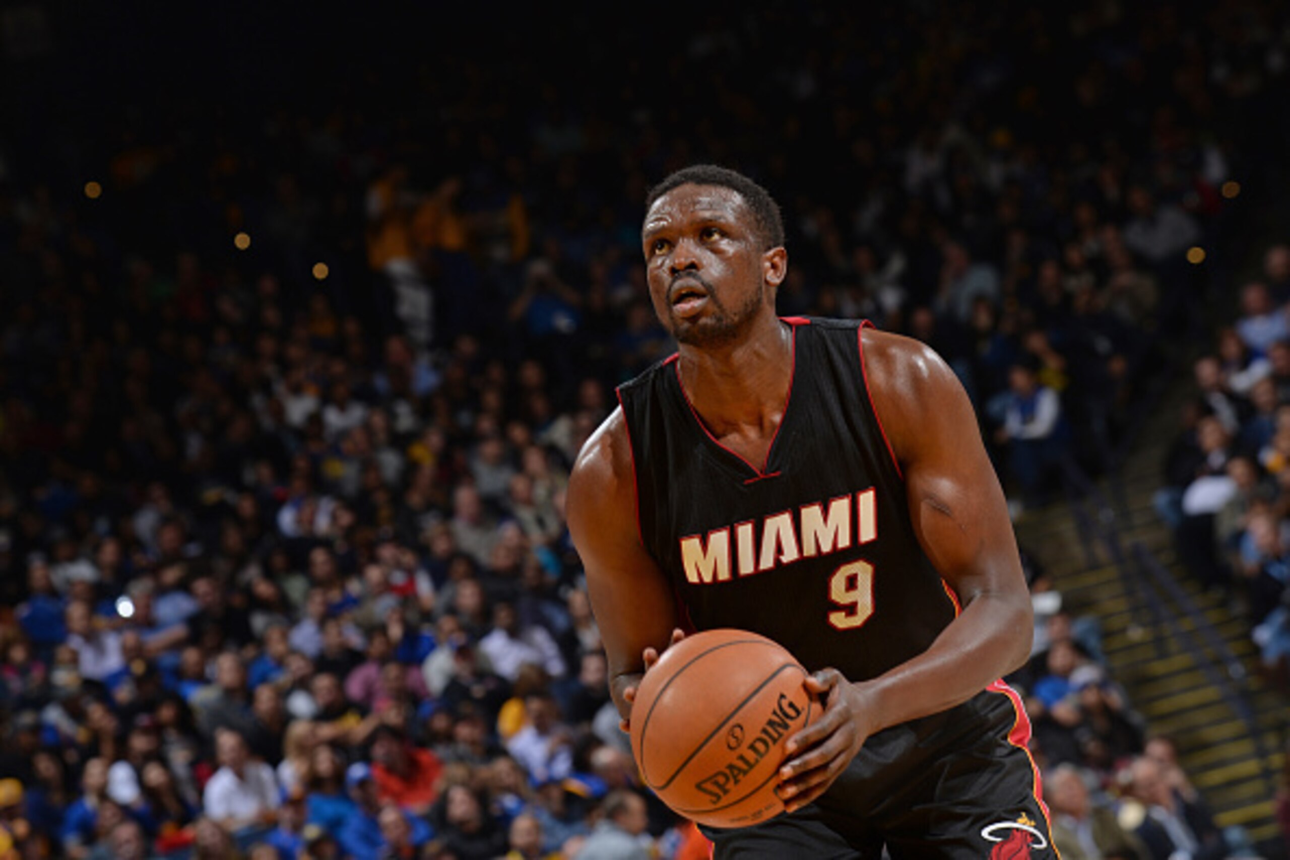 OAKLAND, CA - JANUARY 14: Luol Deng #9 of the Miami Heat attempts a free throw against the Golden State Warriors on January 14, 2015 at Oracle Arena in Oakland, California. NOTE TO USER: User expressly acknowledges and agrees that, by downloading and or u