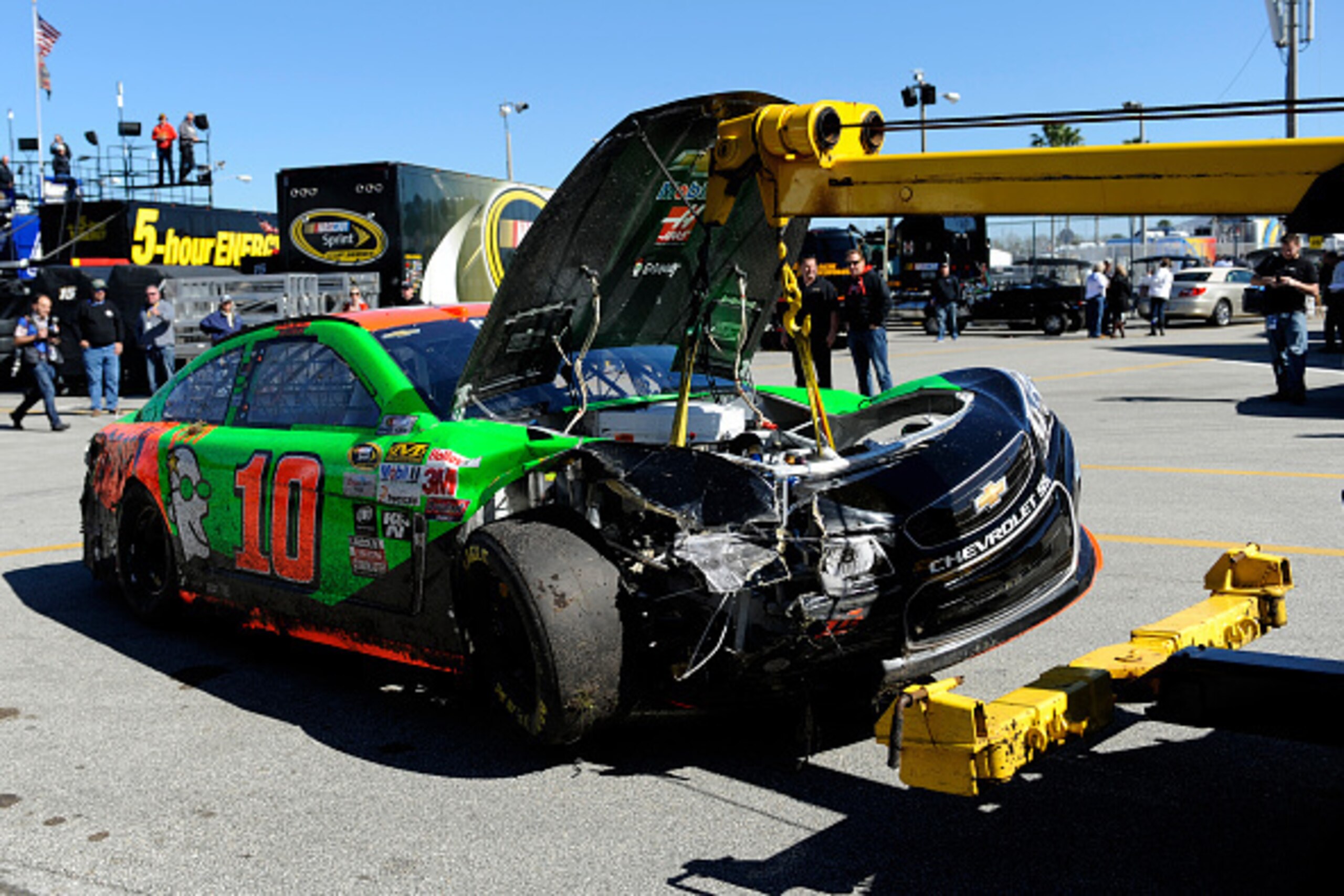 DAYTONA BEACH, FL - FEBRUARY 18:  The damaged #10 GoDaddy Chevrolet of Danica Patrick is towed through the garage area after an incident during practice for the 57th Annual Daytona 500 at Daytona International Speedway on February 18, 2015 in Daytona Beac