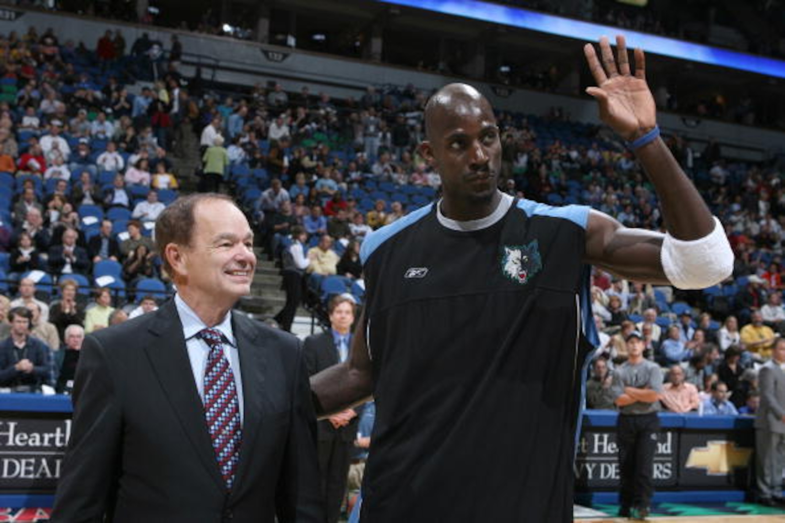 MINNEAPOLIS - NOVEMBER 09:  Kevin Garnett #21 of the Minnesota Timberwolves receives an award from Glen Taylor for being a member of the 2004-05 all-defensive first team and the 2004-05 all-NBA second team prior to tonight's game against the Los Angeles L
