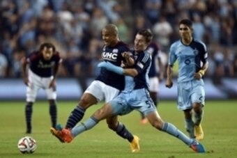 Sep 26, 2014; Kansas City, KS, USA; New England Revolution forward Charlie Davies (9) battles for the ball against Sporting KC defender Matt Besler (5) during the second half at Sporting Park. Mandatory Credit: Peter G. Aiken-USA TODAY Sports