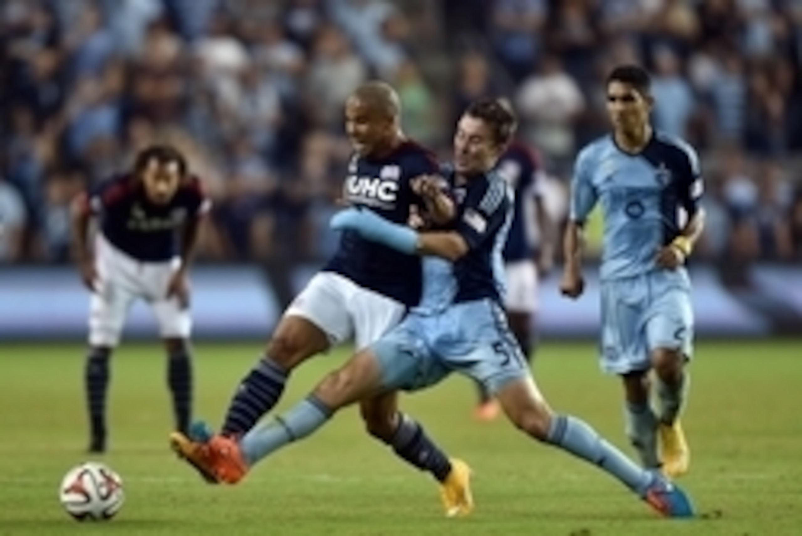 Sep 26, 2014; Kansas City, KS, USA; New England Revolution forward Charlie Davies (9) battles for the ball against Sporting KC defender Matt Besler (5) during the second half at Sporting Park. Mandatory Credit: Peter G. Aiken-USA TODAY Sports