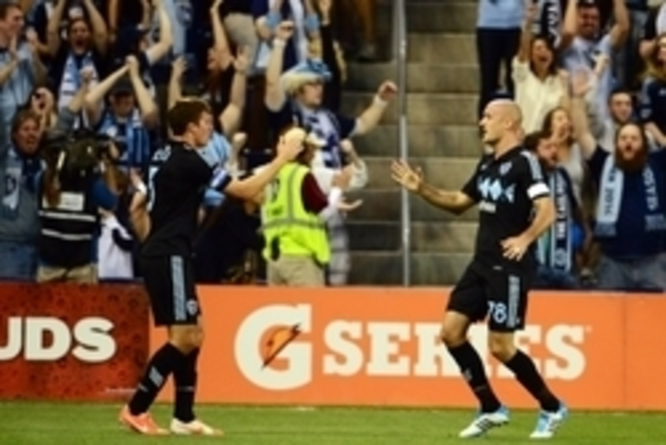 Apr 19, 2014; Kansas City, KS, USA; Sporting KC defender Aurelien Collin (78) celebrates with defender Matt Besler (5) after scoring a goal against the Montreal Impact during the first half at Sporting Park. Mandatory Credit: Jasen Vinlove-USA TODAY Sport