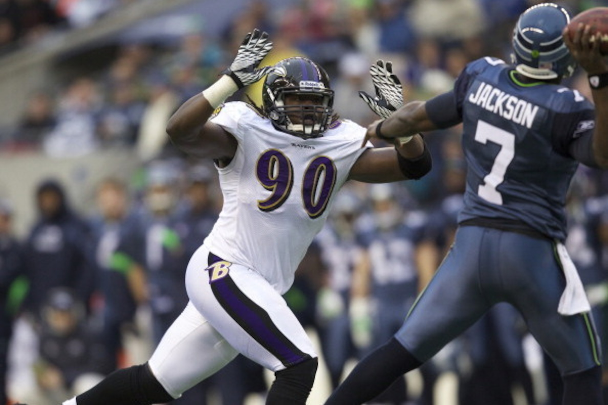 SEATTLE, WA - NOVEMBER 13: Defensive end Pernell McPhee #90 of the Baltimore Ravens pressures quarterback Tarvaris Jackson #7 of the Seattle Seahawks during a game at CenturyLink Field on November 13, 2011 in Seattle, Washington. The Seahawks won the game