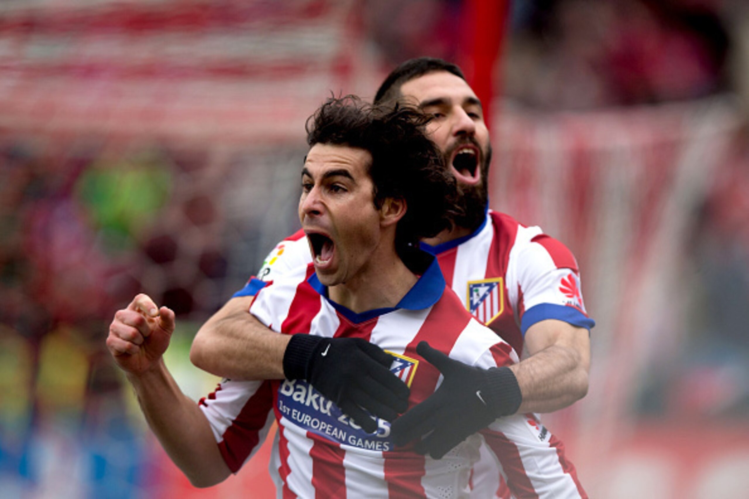 MADRID, SPAIN - FEBRUARY 07:  Tiago Mendes (L) of Atletico de Madrid celebrates scoring their opening goal with teammate Arda Turan (R) during the La Liga match between Club Atletico de Madrid and Real Madrid CF at Vicente Calderon Stadium on February 7, 