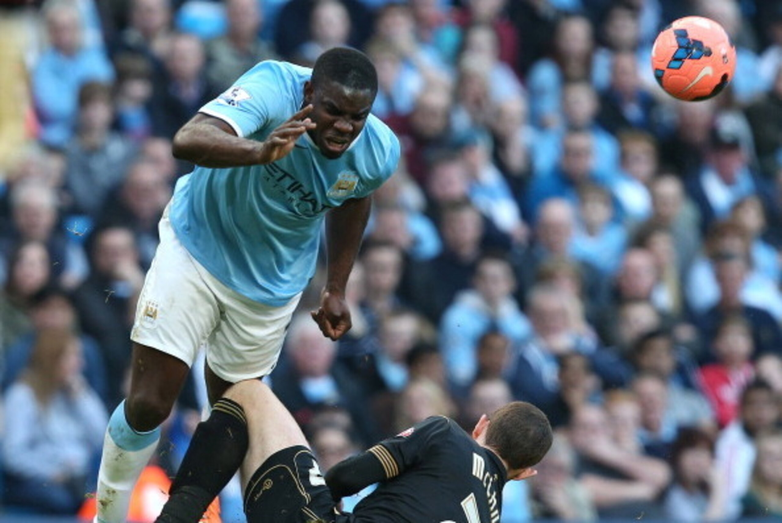 MANCHESTER, ENGLAND - MARCH 09:   Micah Richards of Manchester City is tackled by Chris McCann of Wigan Athletic during the FA Cup Quarter-Final match between Manchester City and Wigan Athletic at the Etihad Stadium on March 9, 2014 in Manchester, England