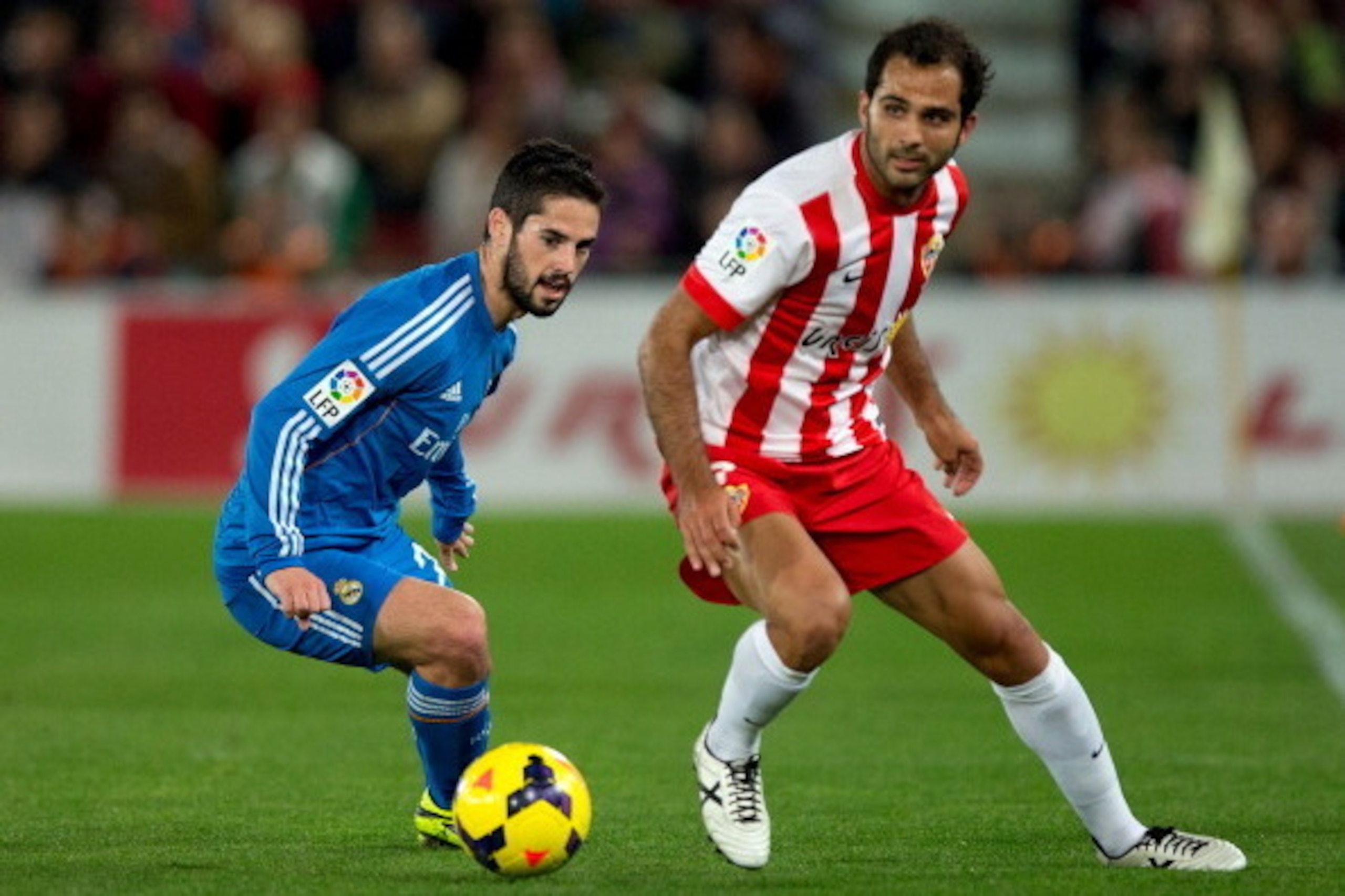 ALMERIA, SPAIN - NOVEMBER 23: Francisco Roman Alarcon alias Isco (L) of Real Madrid CF competes for the ball with Jose Antonio Garcia Rabasco, alias Verza (R) of Almeria UD during the La Liga match between UD Almeria and Real Madrid CF at Estadio de Los J