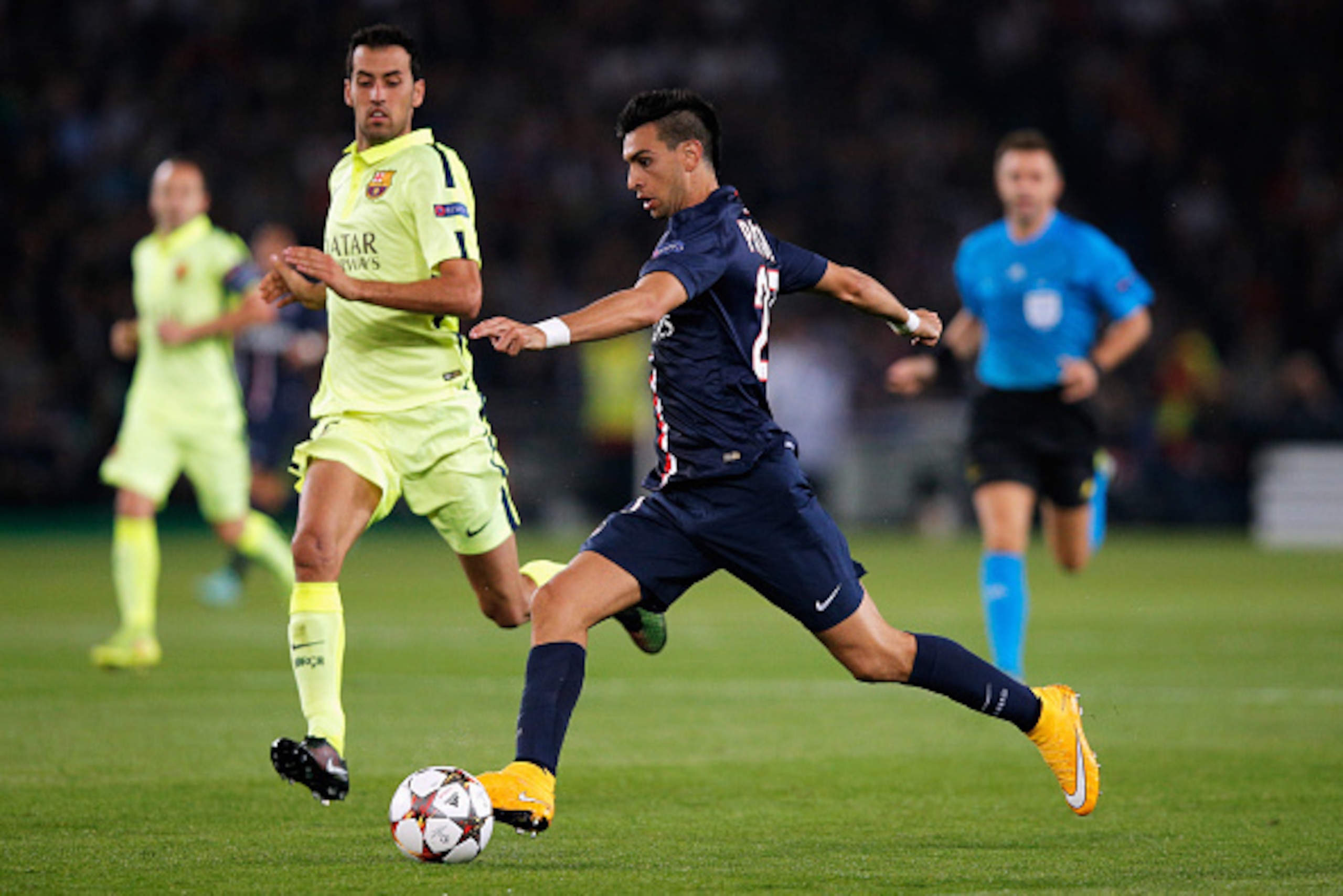 PARIS, FRANCE - SEPTEMBER 30:  Javier Pastore of PSG gets past Sergio Busquets of Barcelona during the Group F UEFA Champions League match between Paris Saint-Germain v FC Barcelona held at Parc des Princes on September 30, 2014 in Paris, France.  (Photo 