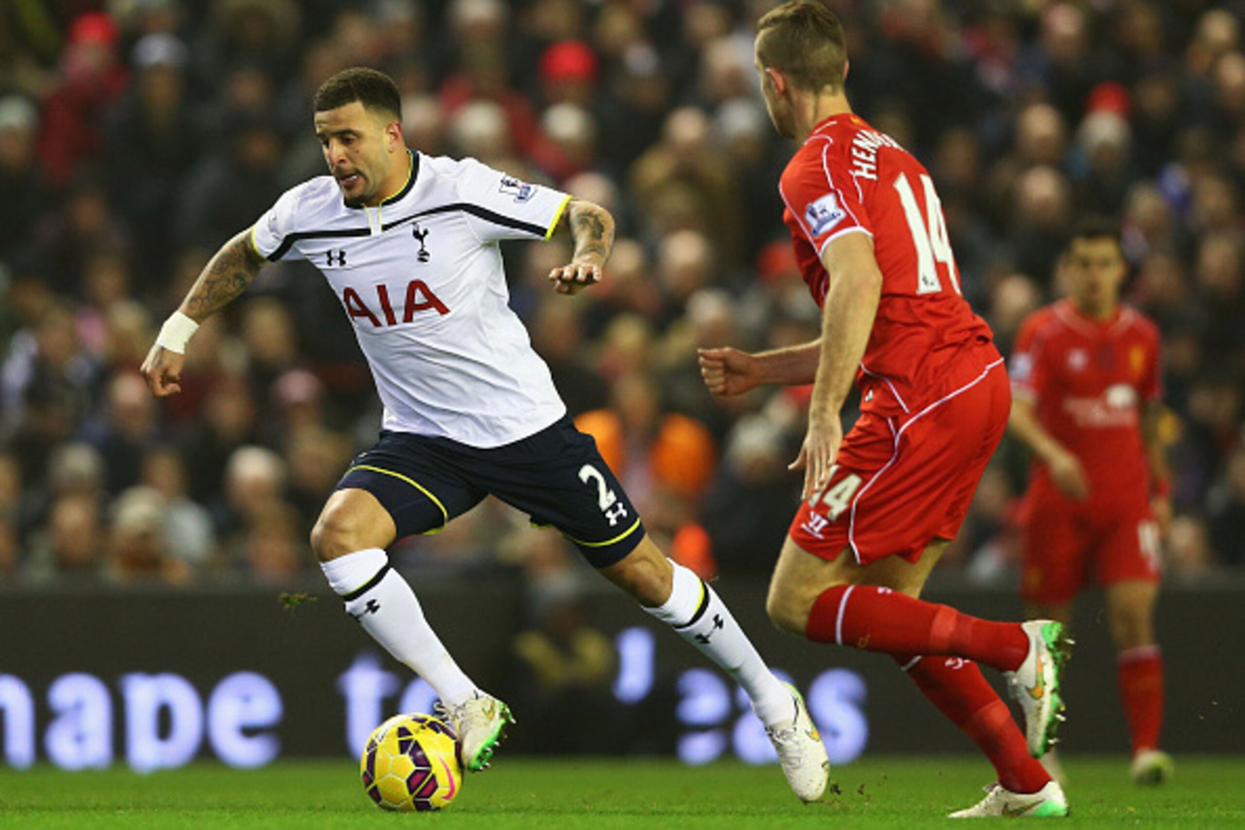 LIVERPOOL, ENGLAND - FEBRUARY 10:  Kyle Walker of Spurs takes on Jordan Henderson of Liverpool during the Barclays Premier League match between Liverpool and Tottenham Hotspur at Anfield on February 10, 2015 in Liverpool, England.  (Photo by Clive Brunski