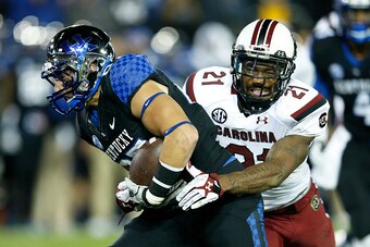 LEXINGTON, KY - OCTOBER 4: Joey Herrick #87 of the Kentucky Wildcats fights for extra yardage after a reception against Marcquis Roberts #21 of the South Carolina Gamecocks during the first half of the game at Commonwealth Stadium on October 4, 2014 in Le