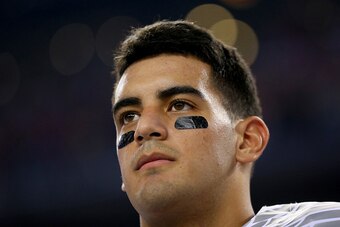 ARLINGTON, TX - JANUARY 12:  Quarterback Marcus Mariota #8 of the Oregon Ducks looks on during the national anthem before the College Football Playoff National Championship Game at AT&T Stadium on January 12, 2015 in Arlington, Texas.  (Photo by Ronald Ma