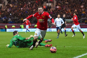 PRESTON, ENGLAND - FEBRUARY 16:  Wayne Rooney of Manchester United draws a foul from Thorsten Stuckmann of Preston North End to win a penalty during the FA Cup Fifth round match between Preston North End and Manchester United at Deepdale on February 16, 2