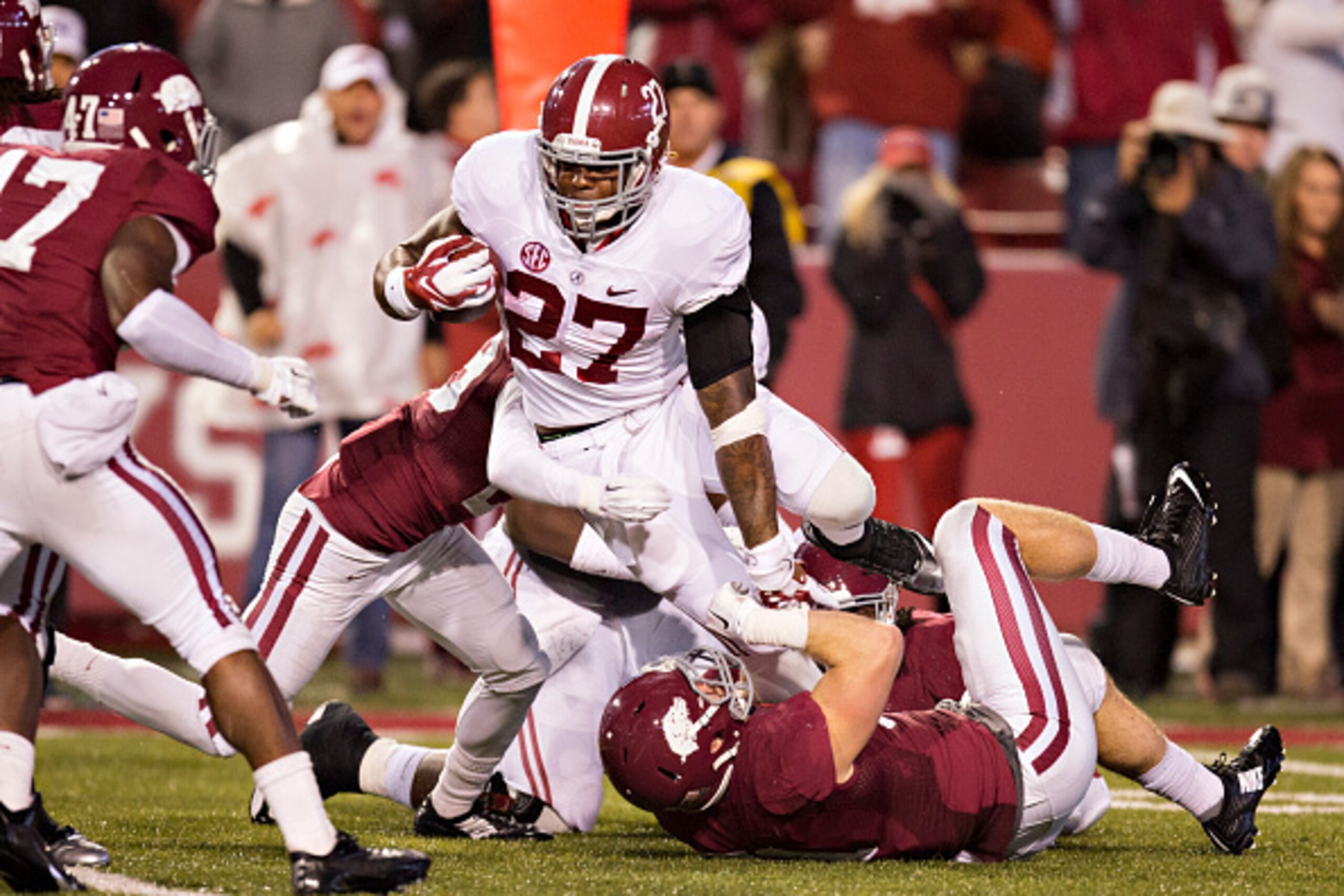 FAYETTEVILLE, AR - OCTOBER 11:  Derrick Henry #27 of the Alabama Crimson Tide runs the ball against the Arkansas Razorbacks at Razorback Stadium on October 11, 2014 in Fayetteville, Arkansas.  The Crimson Tide defeated the Razorbacks 14-13.  (Photo by Wes