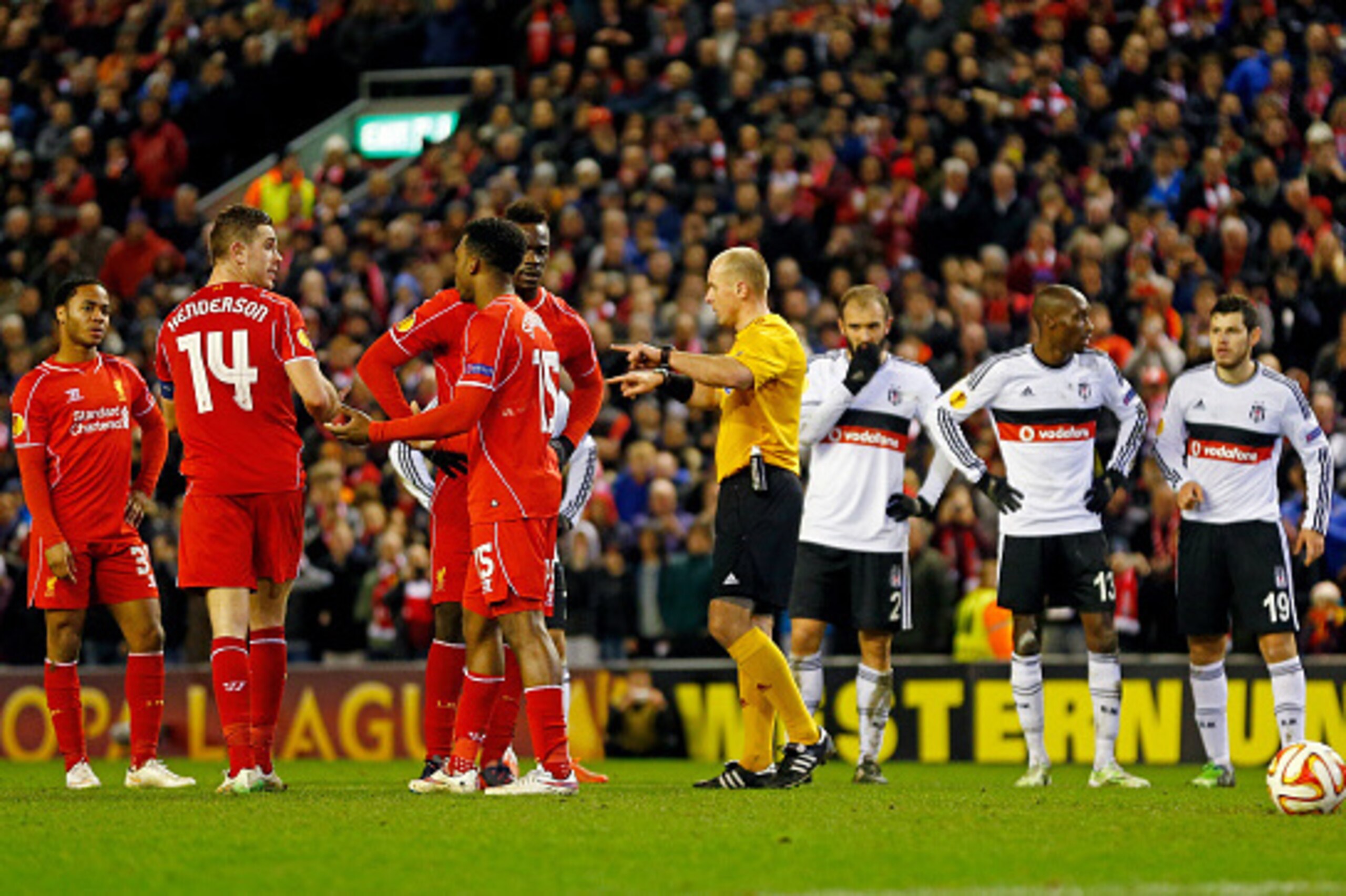 LIVERPOOL, ENGLAND - FEBRUARY 19:  Daniel Sturridge #15 of Liverpool separates Jordan Henderson #14 of Liverpool and Mario Balotelli #45 of Liverpool as they argue about who is going to take the penalty awarded to their team during the UEFA Europa League 