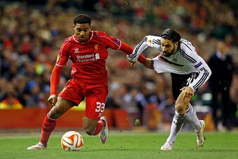 LIVERPOOL, ENGLAND - FEBRUARY 19:  Jordon Ibe of Liverpool goes past Olcay Sahan of Besiktas during the UEFA Europa League Round of 32 match between Liverpool FC and Besiktas JK at Anfield on February 19, 2015 in Liverpool, United Kingdom.  (Photo by Juli