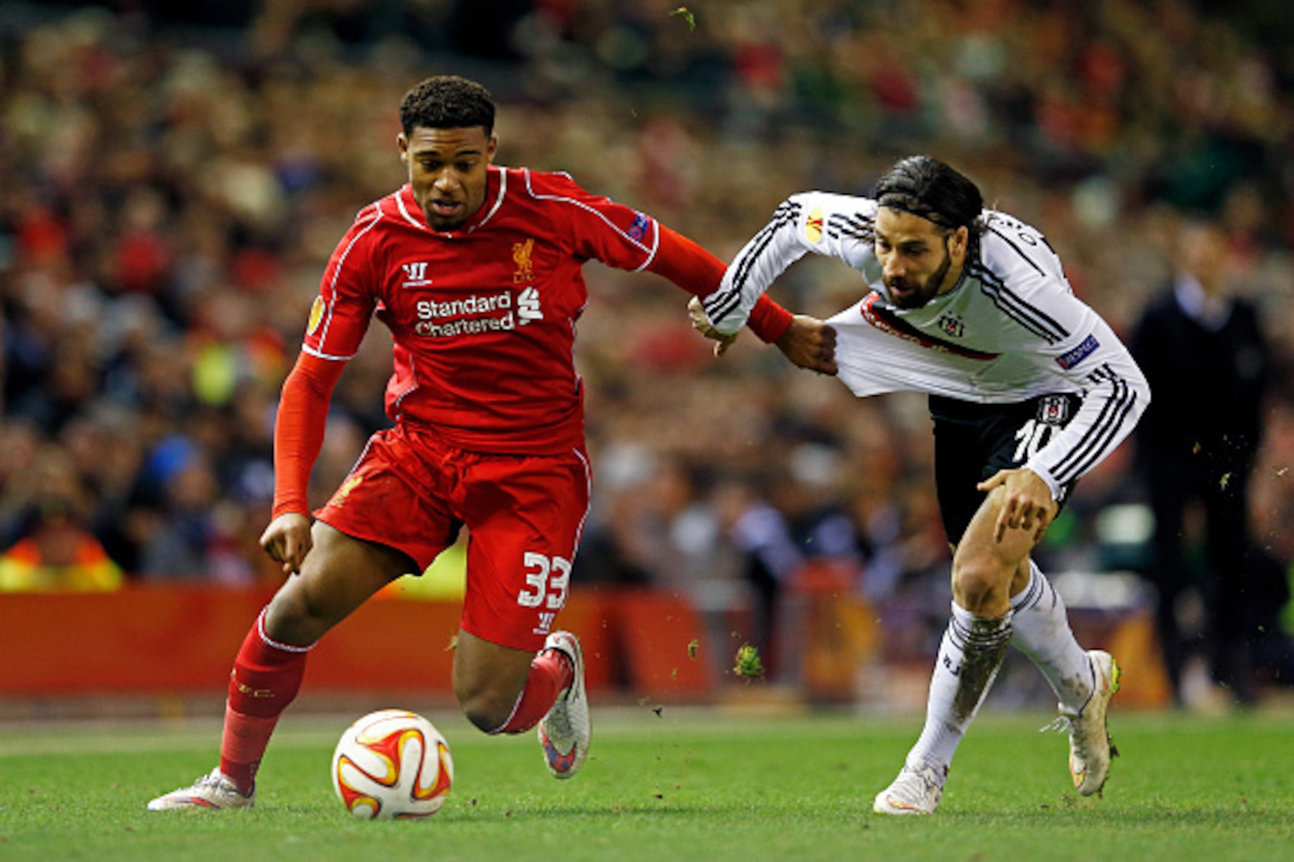 LIVERPOOL, ENGLAND - FEBRUARY 19:  Jordon Ibe of Liverpool goes past Olcay Sahan of Besiktas during the UEFA Europa League Round of 32 match between Liverpool FC and Besiktas JK at Anfield on February 19, 2015 in Liverpool, United Kingdom.  (Photo by Juli