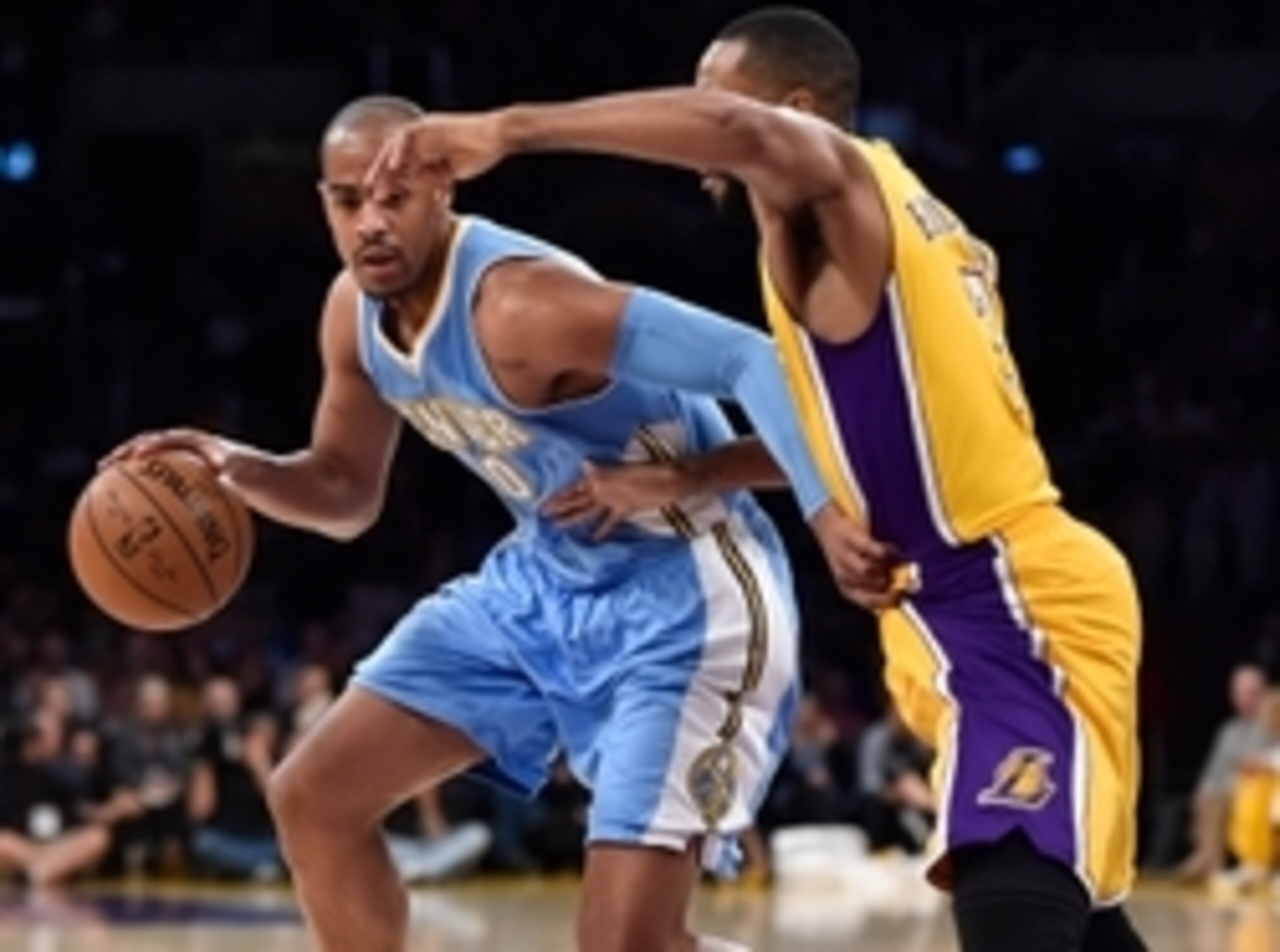 Feb 10, 2015; Los Angeles, CA, USA; Denver Nuggets guard Arron Afflalo (10) dribbles the ball as Los Angeles Lakers guard Wayne Ellington (2) defends during first quarter action at Staples Center. Mandatory Credit: Robert Hanashiro-USA TODAY Sports