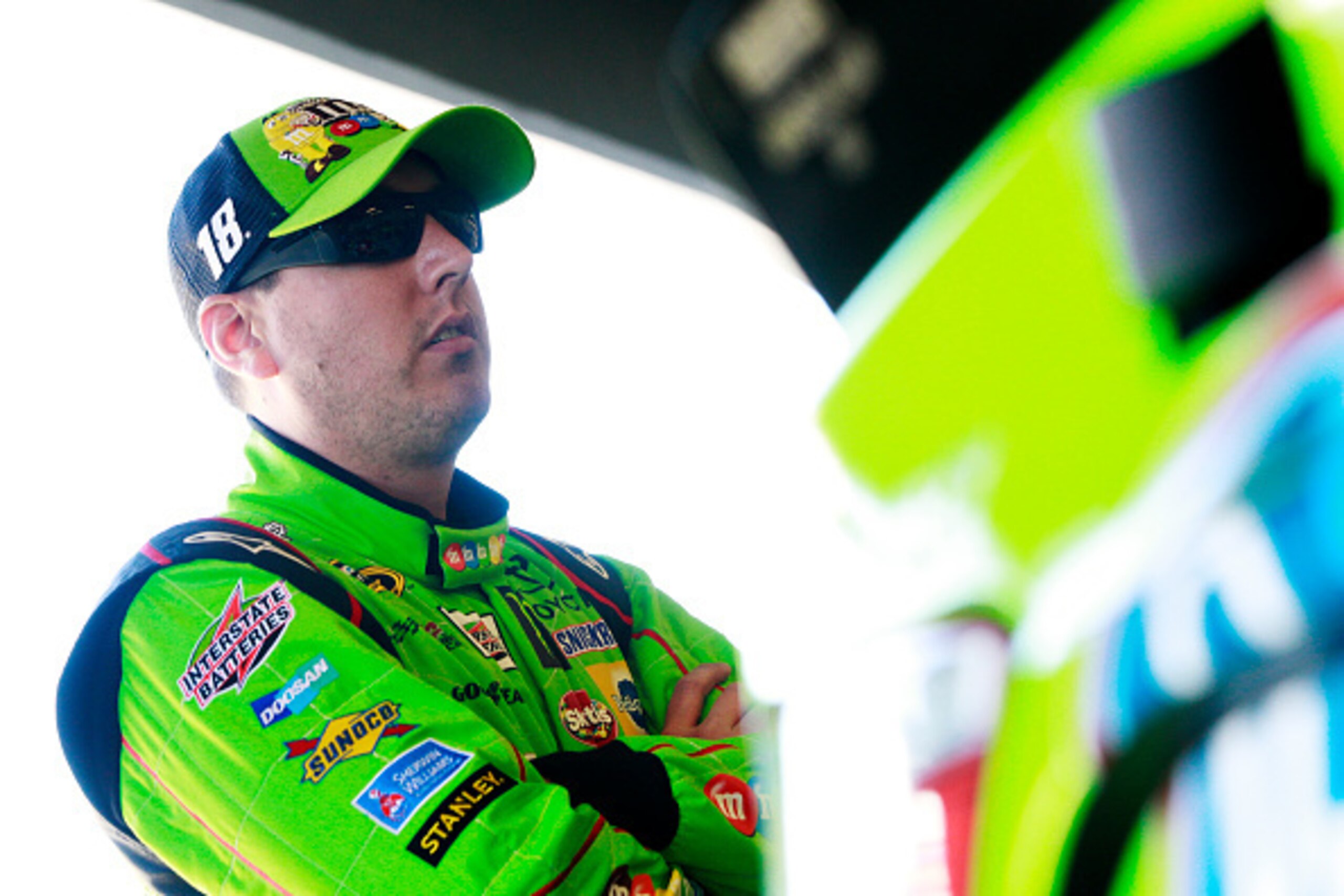DAYTONA BEACH, FL - FEBRUARY 18:  Kyle Busch, driver of the #18 M&M's Crispy Toyota, stands in the garage area during practice for the 57th Annual Daytona 500 at Daytona International Speedway on February 18, 2015 in Daytona Beach, Florida.  (Photo by Bri