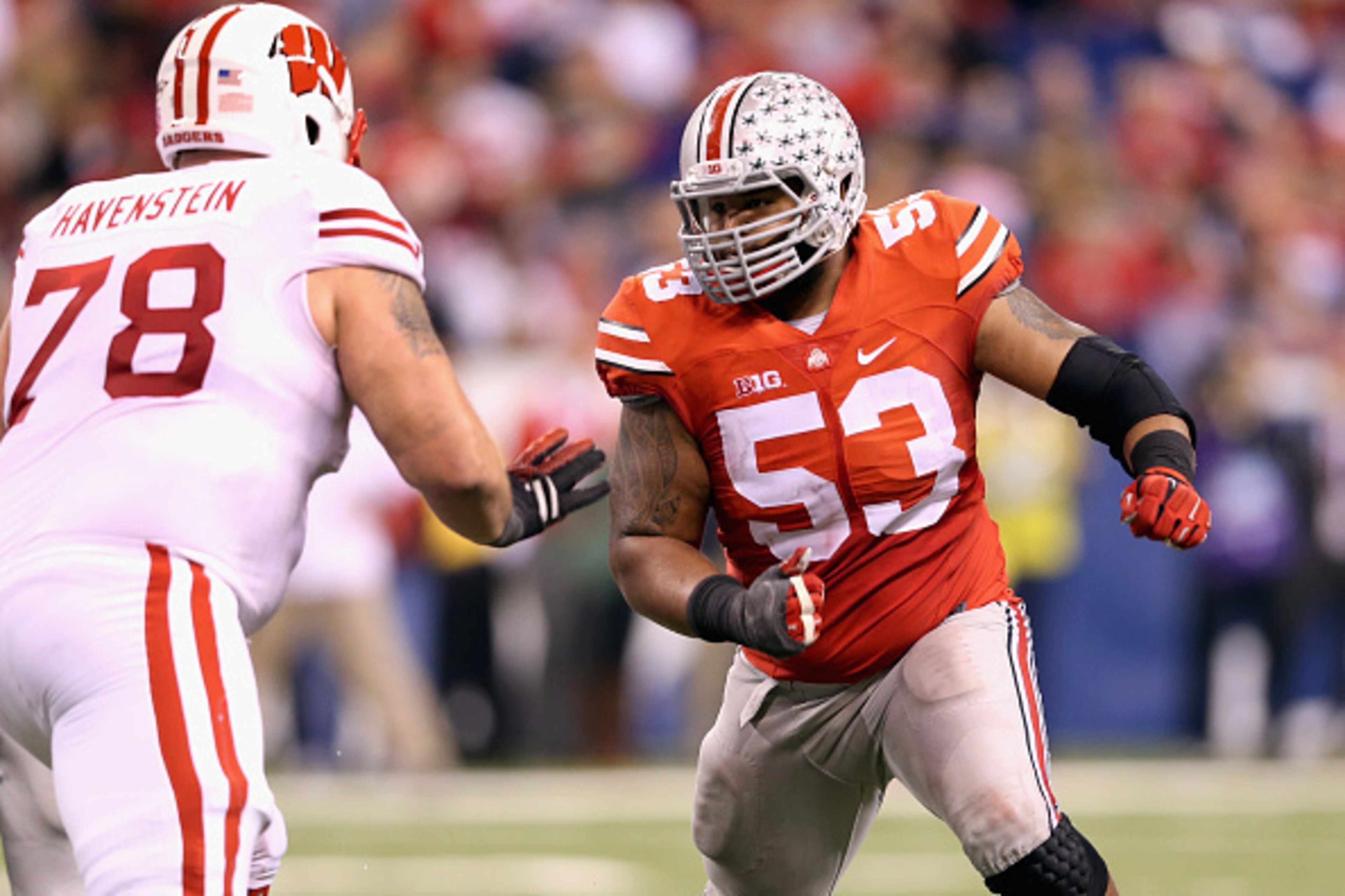 INDIANAPOLIS, IN - DECEMBER 06: Defensive lineman Michael Bennett wears #53 to honor late teammate Kosta Karageorge of the Ohio State Buckeyes while playing in the Big Ten Championship against the Wisconsin Badgers at Lucas Oil Stadium on December 6, 201 INDIANAPOLIS, IN - DECEMBER 06: Defensive lineman Michael Bennett wears #53 to honor late teammate Kosta Karageorge of the Ohio State Buckeyes while playing in the Big Ten Championship against the Wisconsin Badgers at Lucas Oil Stadium on December 6, 201