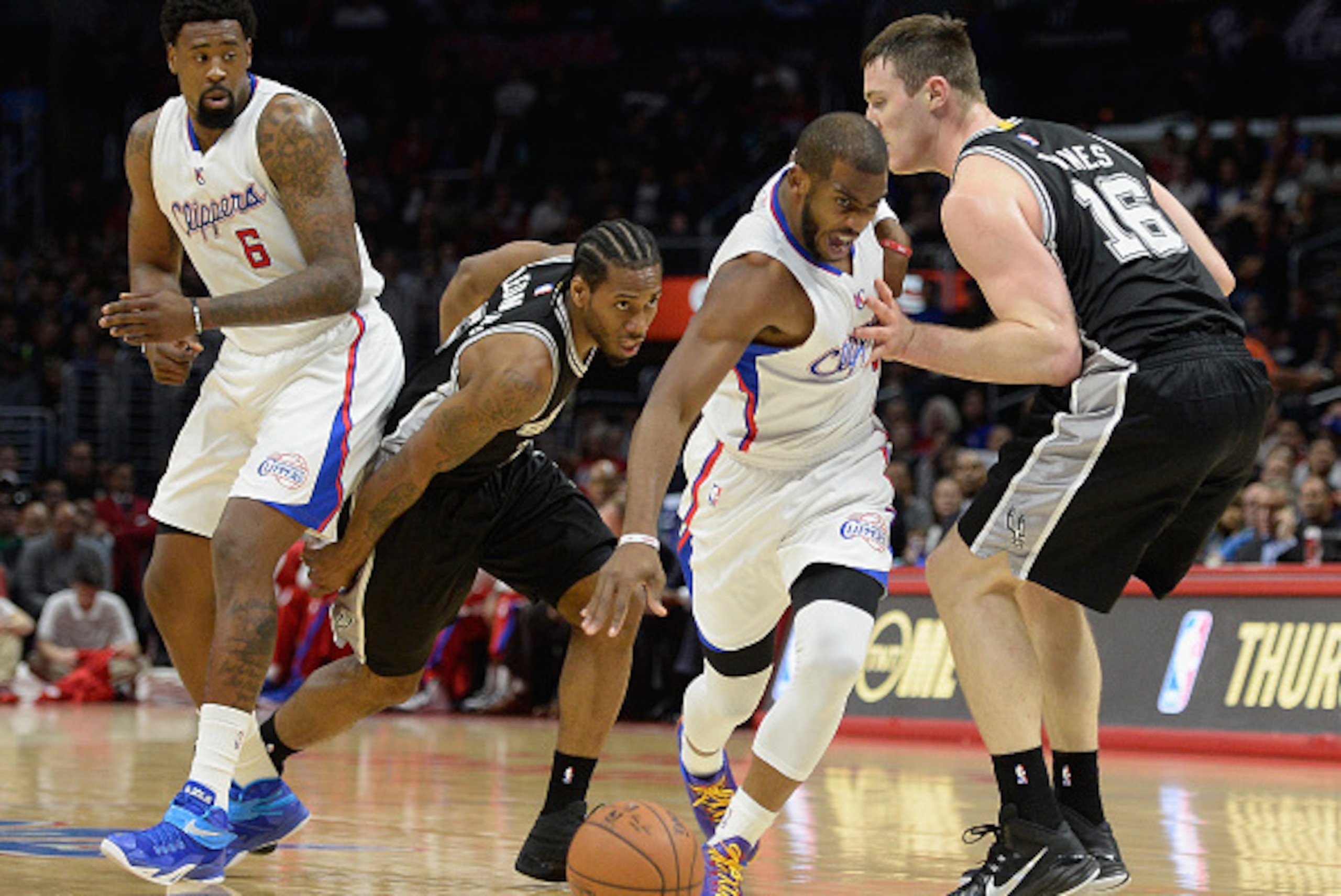 LOS ANGELES, CA - FEBRUARY 19: Chris Paul #3 of the Los Angeles Clippers splits the defense of Aron Baynes #16 and Kawhi Leonard #2 of the San Antonio Spurs as DeAndre Jordan #6 watches at Staples Center on February 19, 2015 in Los Angeles, California. LOS ANGELES, CA - FEBRUARY 19: Chris Paul #3 of the Los Angeles Clippers splits the defense of Aron Baynes #16 and Kawhi Leonard #2 of the San Antonio Spurs as DeAndre Jordan #6 watches at Staples Center on February 19, 2015 in Los Angeles, California.
