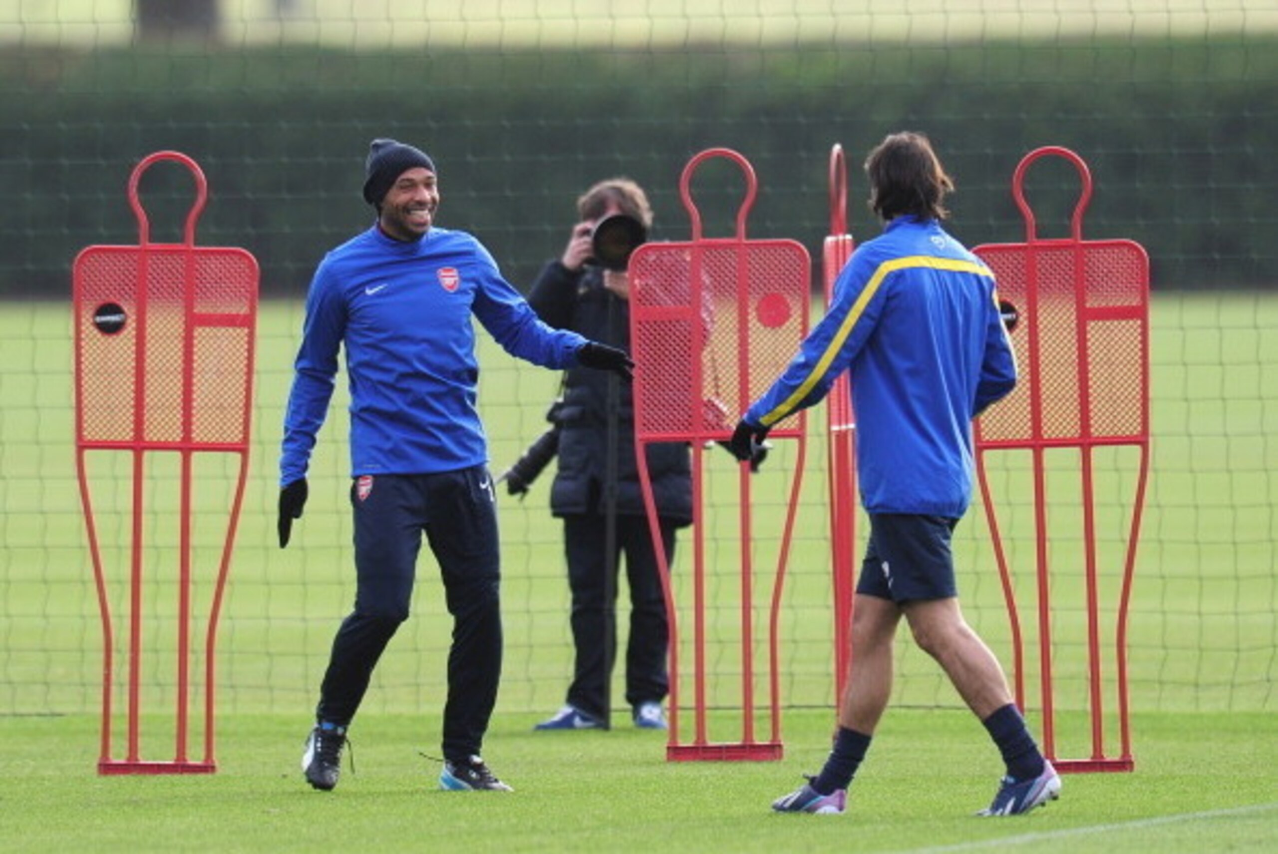 ST ALBANS, ENGLAND - NOVEMBER 25:  Former Arsenal players Thierry Henry and Robert Pires warm up during a training session at London Colney on November 25, 2013 in St Albans, England.  (Photo by Shaun Botterill/Getty Images)