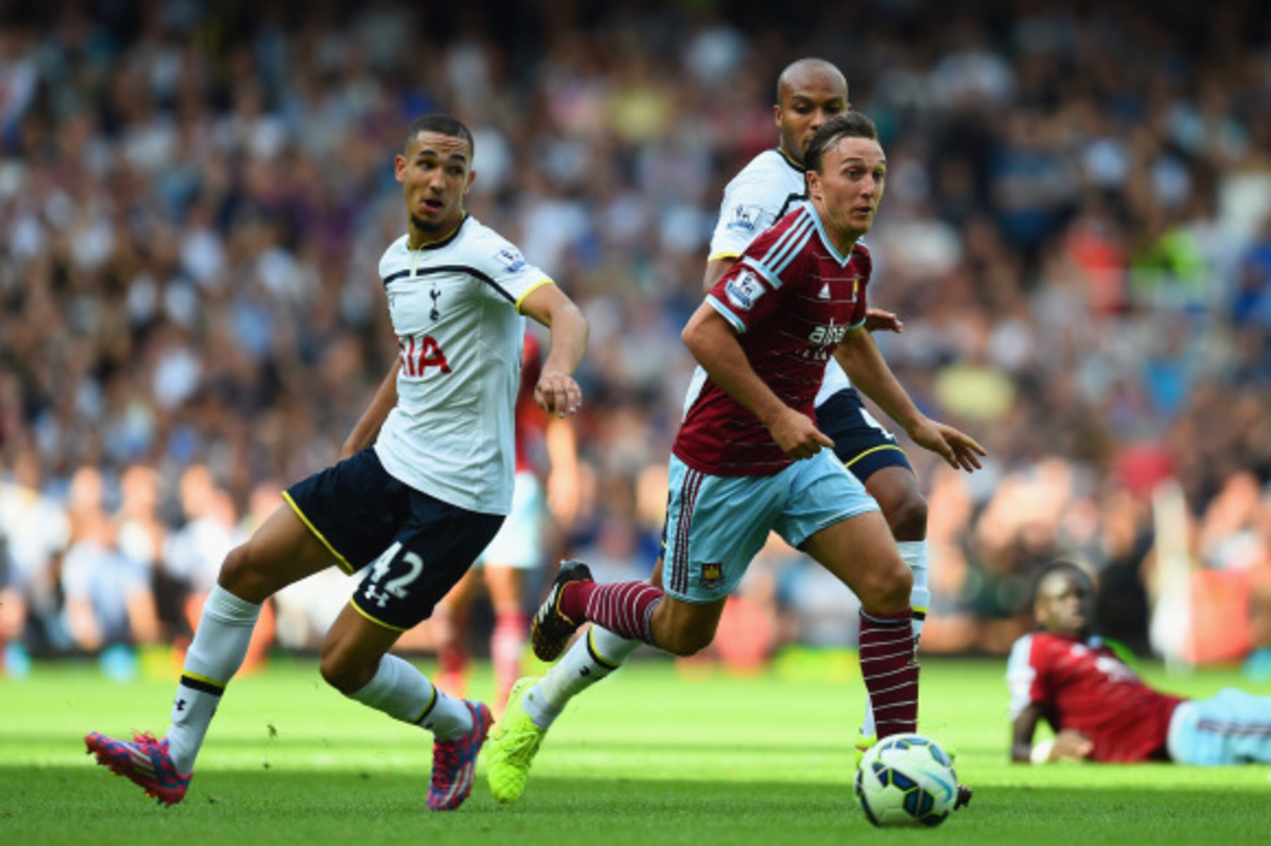 LONDON, ENGLAND - AUGUST 16:  Mark Noble of West Ham goes past Nabil Bentaleb of Spurs during the Barclays Premier League match between West Ham United and Tottenham Hotspur at Boleyn Ground on August 16, 2014 in London, England.  (Photo by Jamie McDonald
