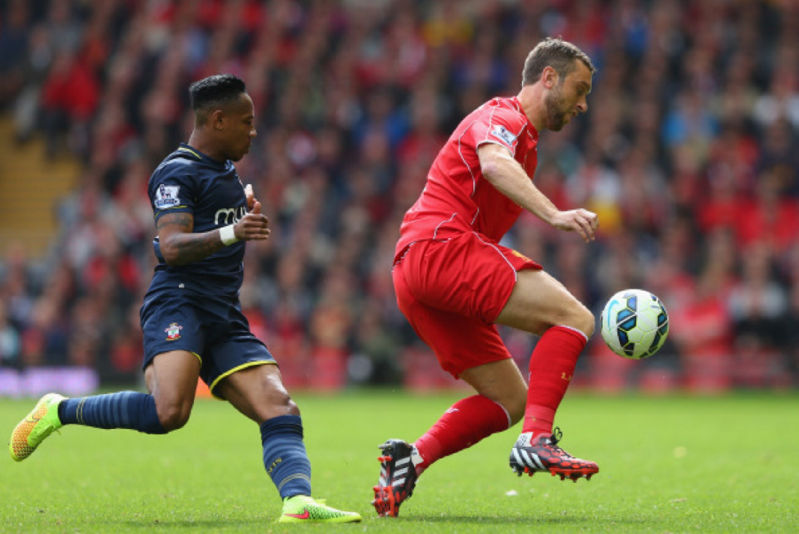 LIVERPOOL, ENGLAND - AUGUST 17:  Rickie Lambert of Liverpool turns away from Nathaniel Clyne of Southampton during the Barclays Premier League match between Liverpool and Southampton at Anfield on August 17, 2014 in Liverpool, England.  (Photo by Alex Liv