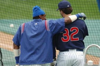 CHICAGO - JUNE 4:  Right fielder Sammy Sosa #21 of the Chicago Cubs hugs teammate Eric Karros #32 during batting practice prior to the game against the Tampa Bay Devil Rays at Wrigley Field on June 4, 2003 in Chicago, Illinois.   Sosa was ejected in the f