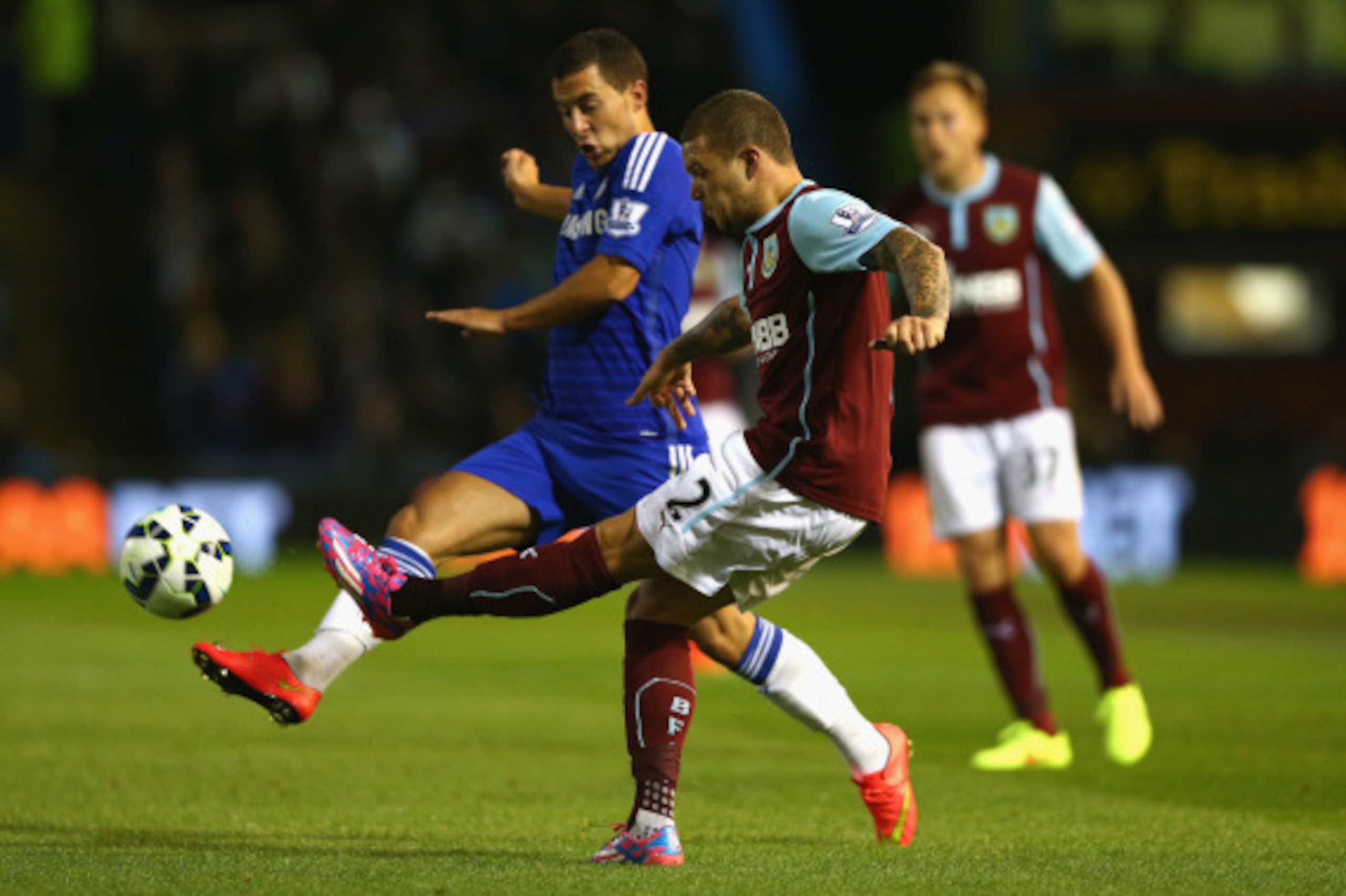 BURNLEY, ENGLAND - AUGUST 18:  Kieran Trippier of Burnley passes the ball under pressure from Eden Hazard of Chelsea during the Barclays Premier League match between Burnley and Chelsea at Turf Moor on August 18, 2014 in Burnley, England.  (Photo by Clive