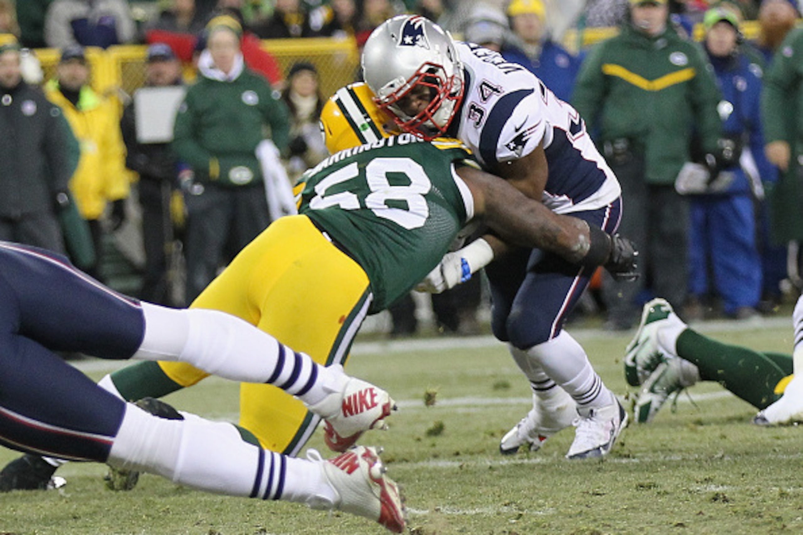 GREEN BAY, WI - NOVEMBER 30:  Inside linebacker Sam Barrington #58 of the Green Bay Packers hits running back Shane Vereen #34 of the New England Patriots in the second quarter at Lambeau Field on November 30, 2014 in Green Bay, Wisconsin.  (Photo by Mike