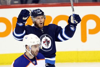 Feb 16, 2015; Winnipeg, Manitoba, CAN; Winnipeg Jets forward Bryan Little (18) celebrates his goal on Edmonton Oilers  goalie Viktor Fasth (35) during the second period at MTS Centre. Mandatory Credit: Bruce Fedyck-USA TODAY Sports