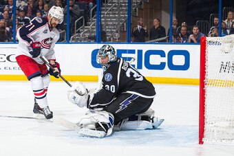 TAMPA, FL - JANUARY 31: Goalie Ben Bishop #30 of the Tampa Bay Lightning makes a save against Nick Foligno #71 of the Columbus Blue Jackets during the second period at the Amalie Arena on January 31, 2015 in Tampa, Florida.  (Photo by Scott Audette/NHLI v