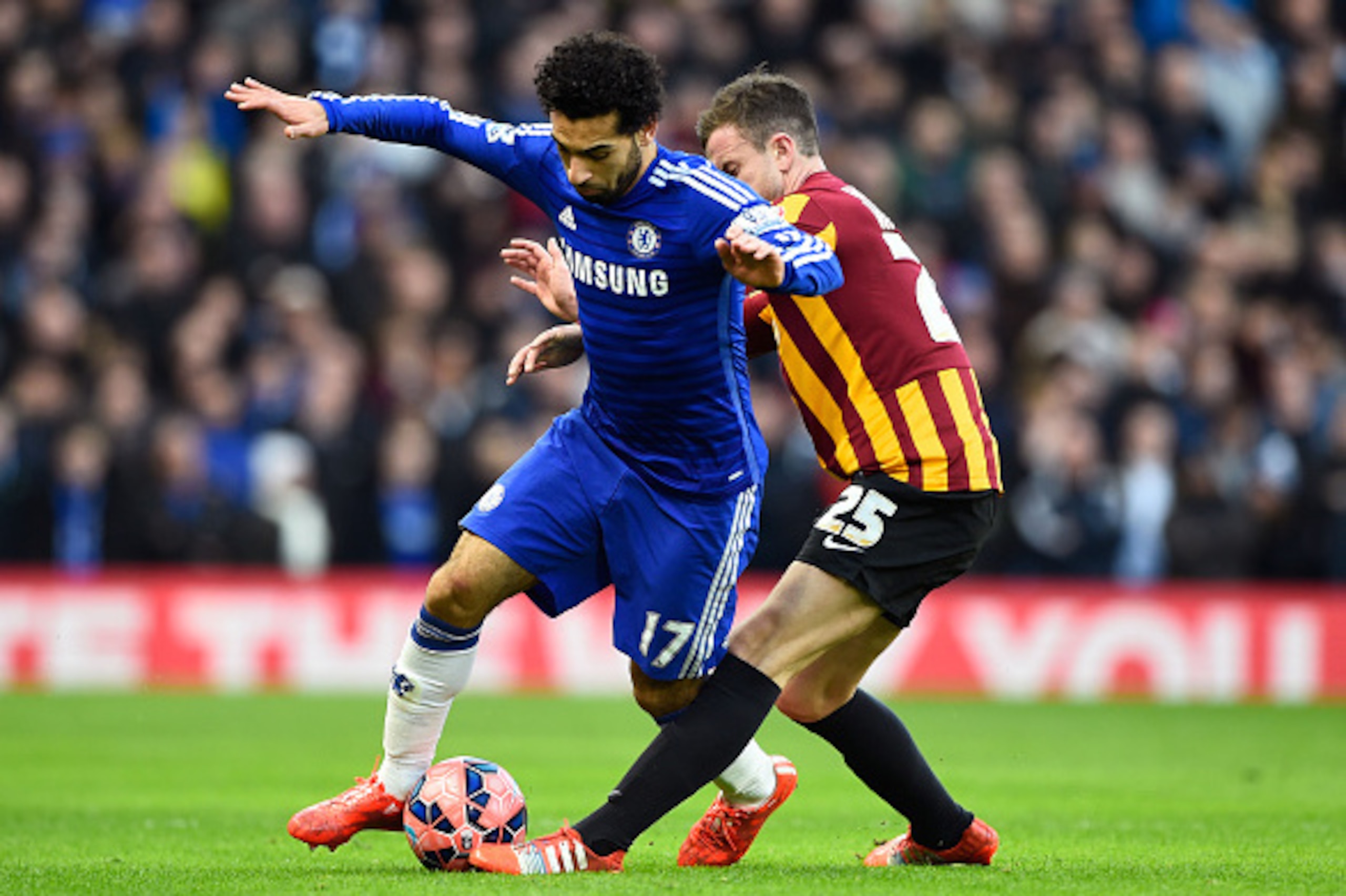 LONDON, ENGLAND - JANUARY 24:  Mohamed Salah of Chelsea is tackled by Andrew Halliday of Bradford City during the FA Cup Fourth Round match between Chelsea and Bradford City at Stamford Bridge on January 24, 2015 in London, England.  (Photo by Mike Hewitt