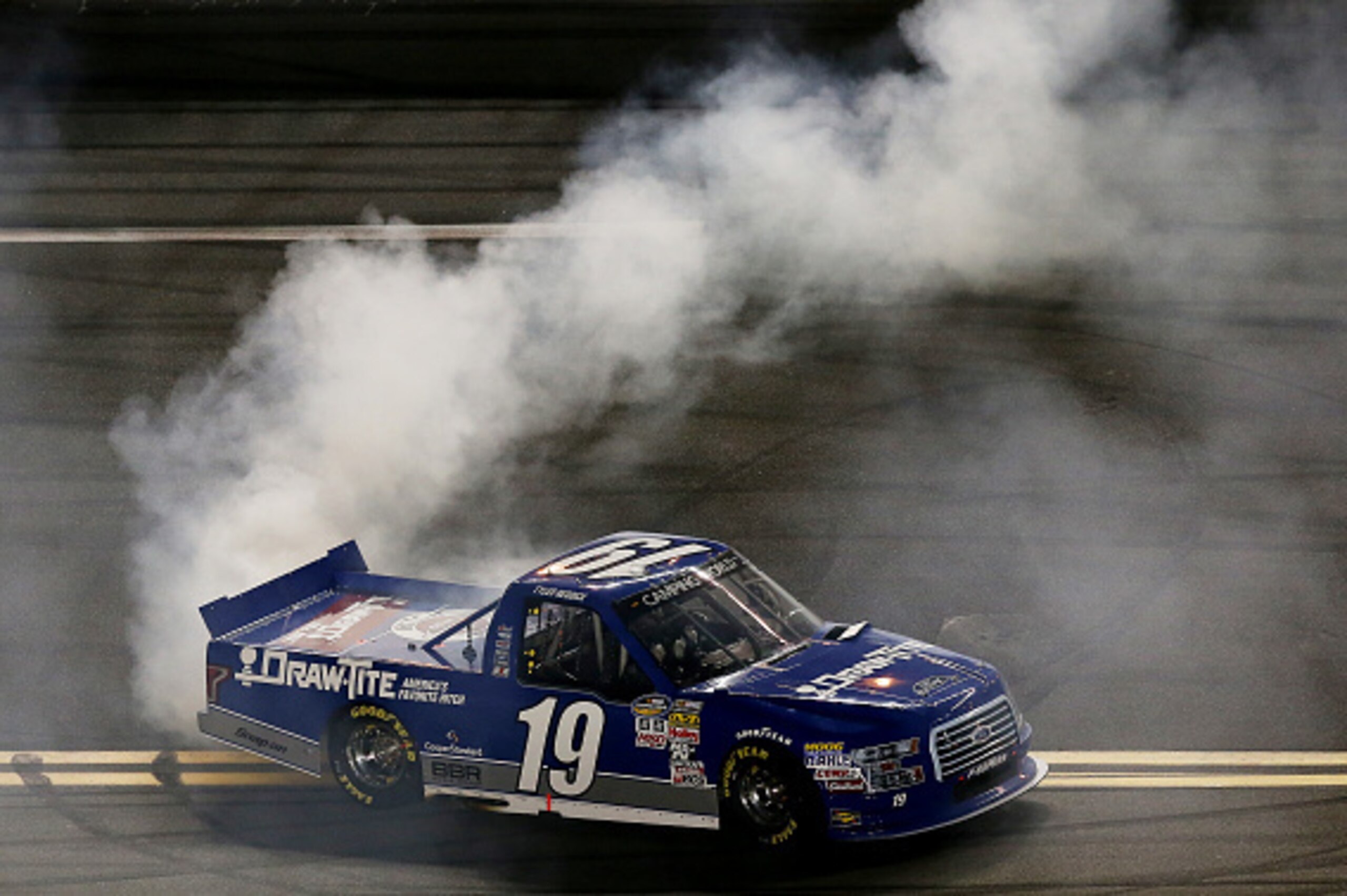 DAYTONA BEACH, FL - FEBRUARY 20: Tyler Reddick, driver of the #19 DrawTite Ford, celebrates with a burnout after winning the NASCAR Camping World Truck Series NextEra Energy Resources 250 at Daytona International Speedway on February 20, 2015 in Daytona DAYTONA BEACH, FL - FEBRUARY 20: Tyler Reddick, driver of the #19 DrawTite Ford, celebrates with a burnout after winning the NASCAR Camping World Truck Series NextEra Energy Resources 250 at Daytona International Speedway on February 20, 2015 in Daytona