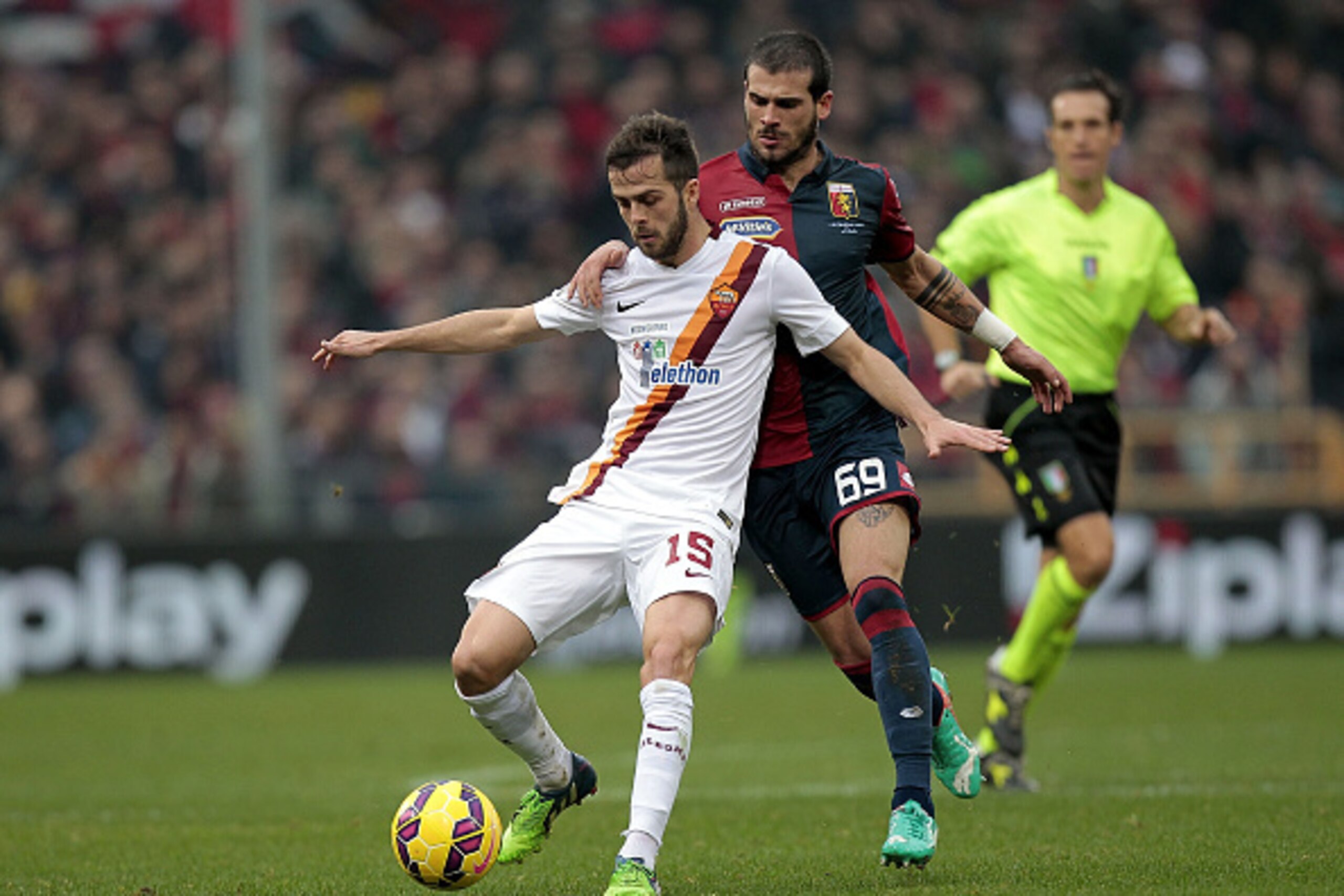 GENOA, ITALY - DECEMBER 14: Stefano Sturaro of Genoa CFC  battles for the ball with Miralem Pjanic of AS Roma during the Serie A match between Genoa CFC and AS Roma at Stadio Luigi Ferraris on December 14, 2014 in Genoa, Italy.  (Photo by Gabriele Maltint