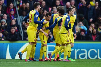 LONDON, ENGLAND - FEBRUARY 21:  Santi Cazorla of Arsenal (3L) celebrates with team mates as he scores their first goal from a penalty during the Barclays Premier League match between Crystal Palace and Arsenal at Selhurst Park on February 21, 2015 in Lond