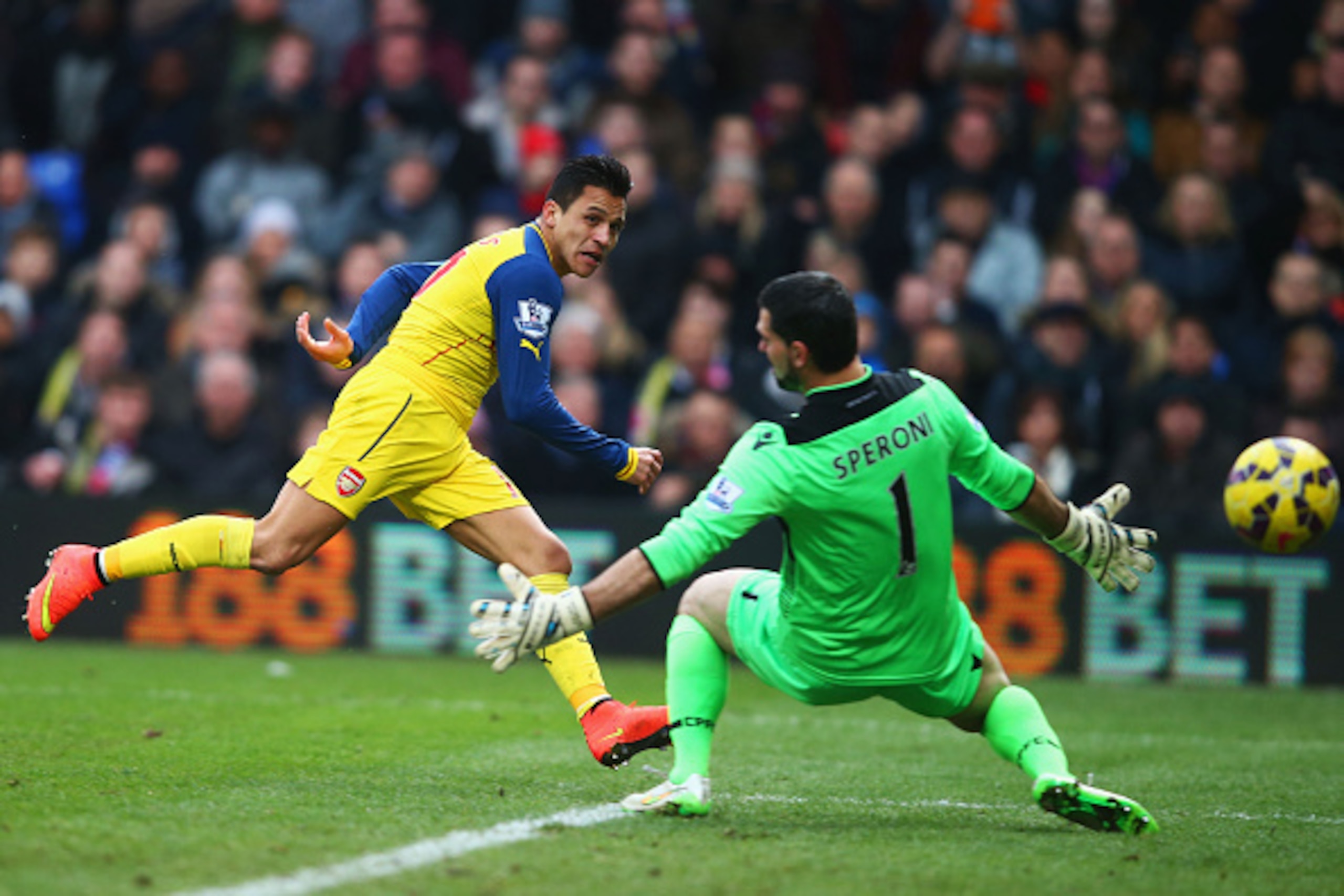 LONDON, ENGLAND - FEBRUARY 21:  Alexis Sanchez of Arsenal shoots past goalkeeper Julian Speroni of Crystal Palace during the Barclays Premier League match between Crystal Palace and Arsenal at Selhurst Park on February 21, 2015 in London, England.  (Photo