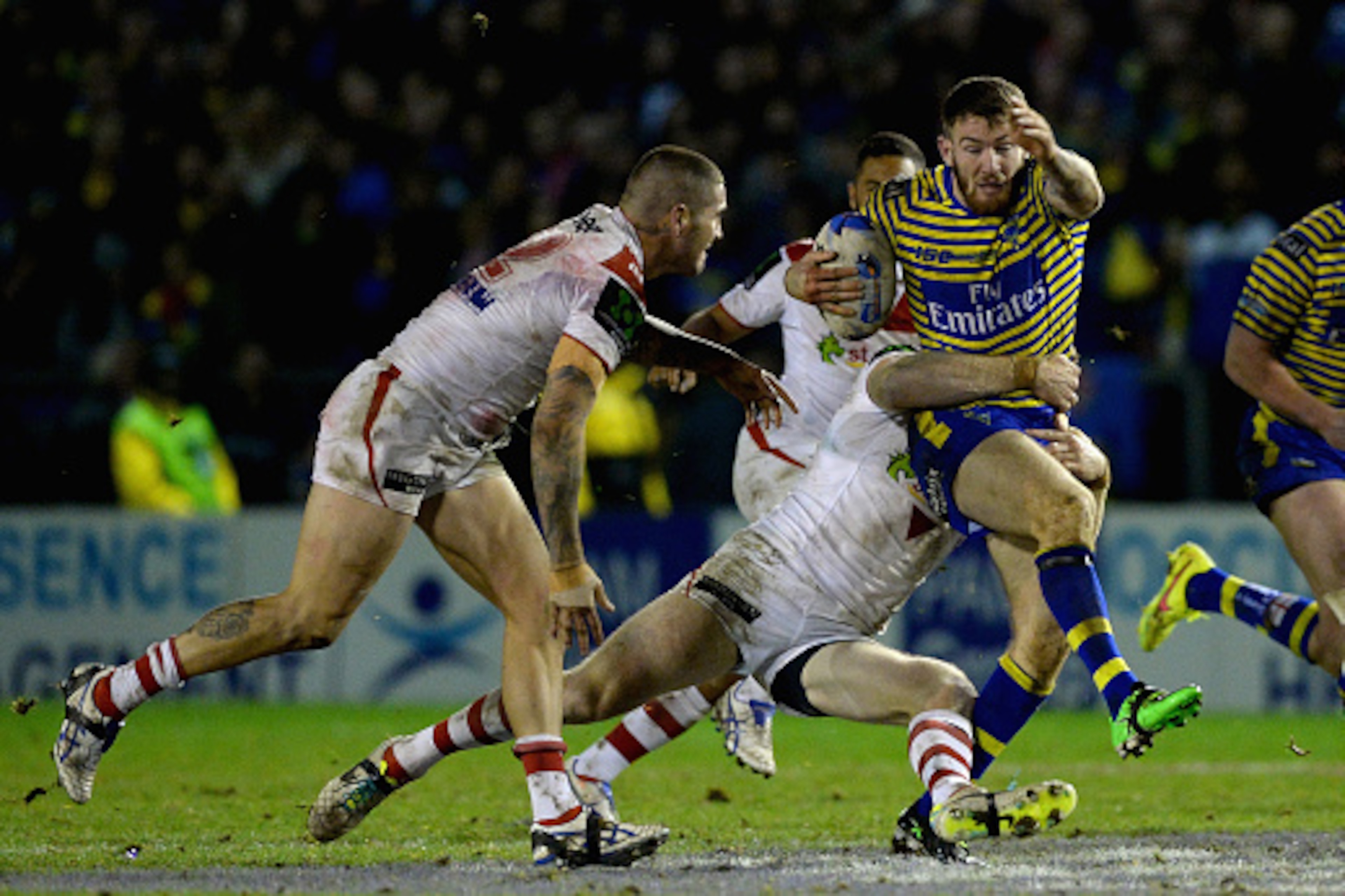 WARRINGTON, ENGLAND - FEBRUARY 20:  Daryl Clark of Warrington Wolves is tackled by Josh Dugan of St George Illawarra Dragons during the World Club Series match between Warrington Wolves and St George Illawarra Dragons at The Halliwell Jones Stadium on Feb
