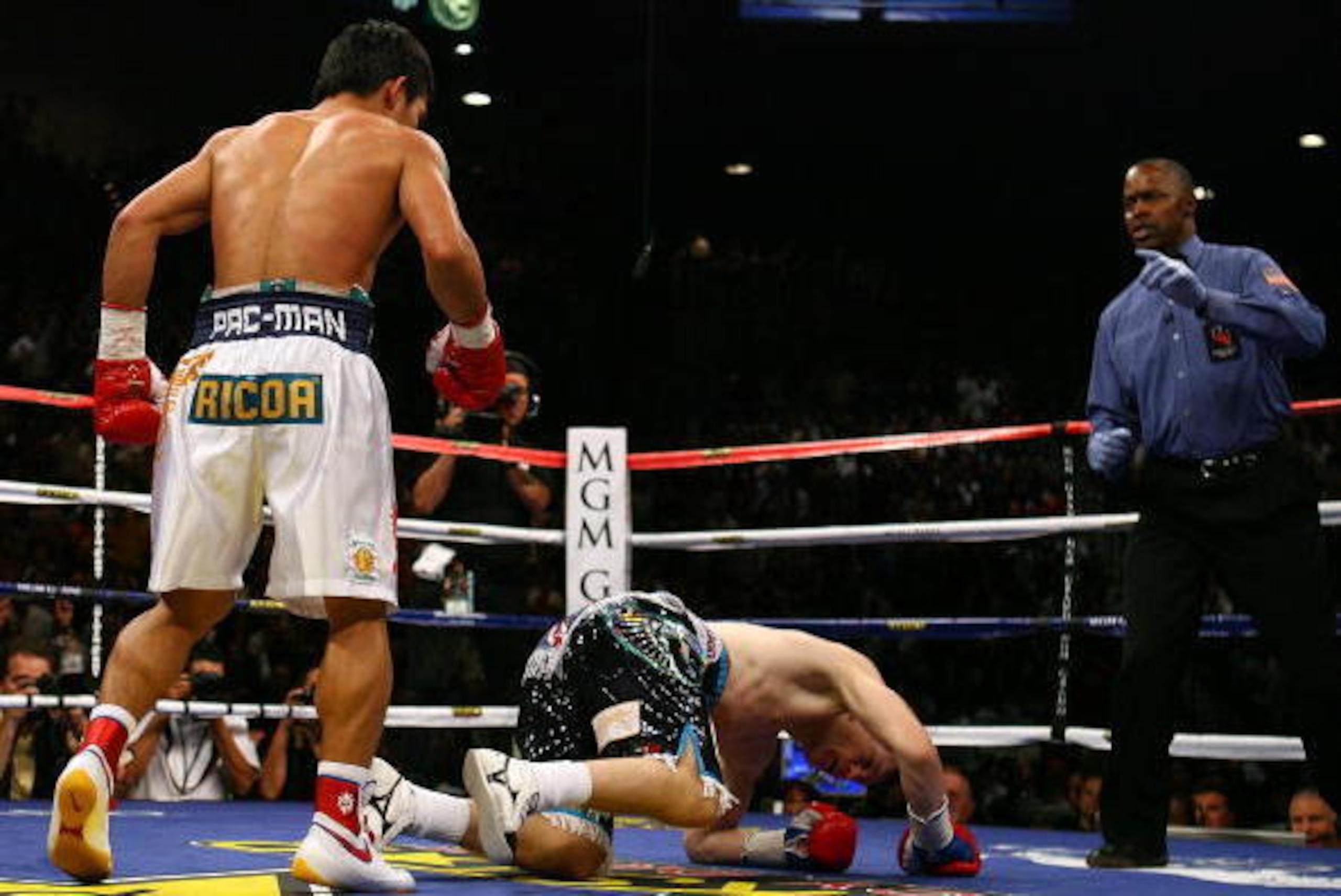 LAS VEGAS - MAY 02:  (L-R) Manny Pacquiao of the Philippines knocks down Ricky Hatton of England in the first round during their junior welterweight title fight at the MGM Grand Garden Arena May 2, 2009 in Las Vegas, Nevada.  (Photo by Al Bello/Getty Imag
