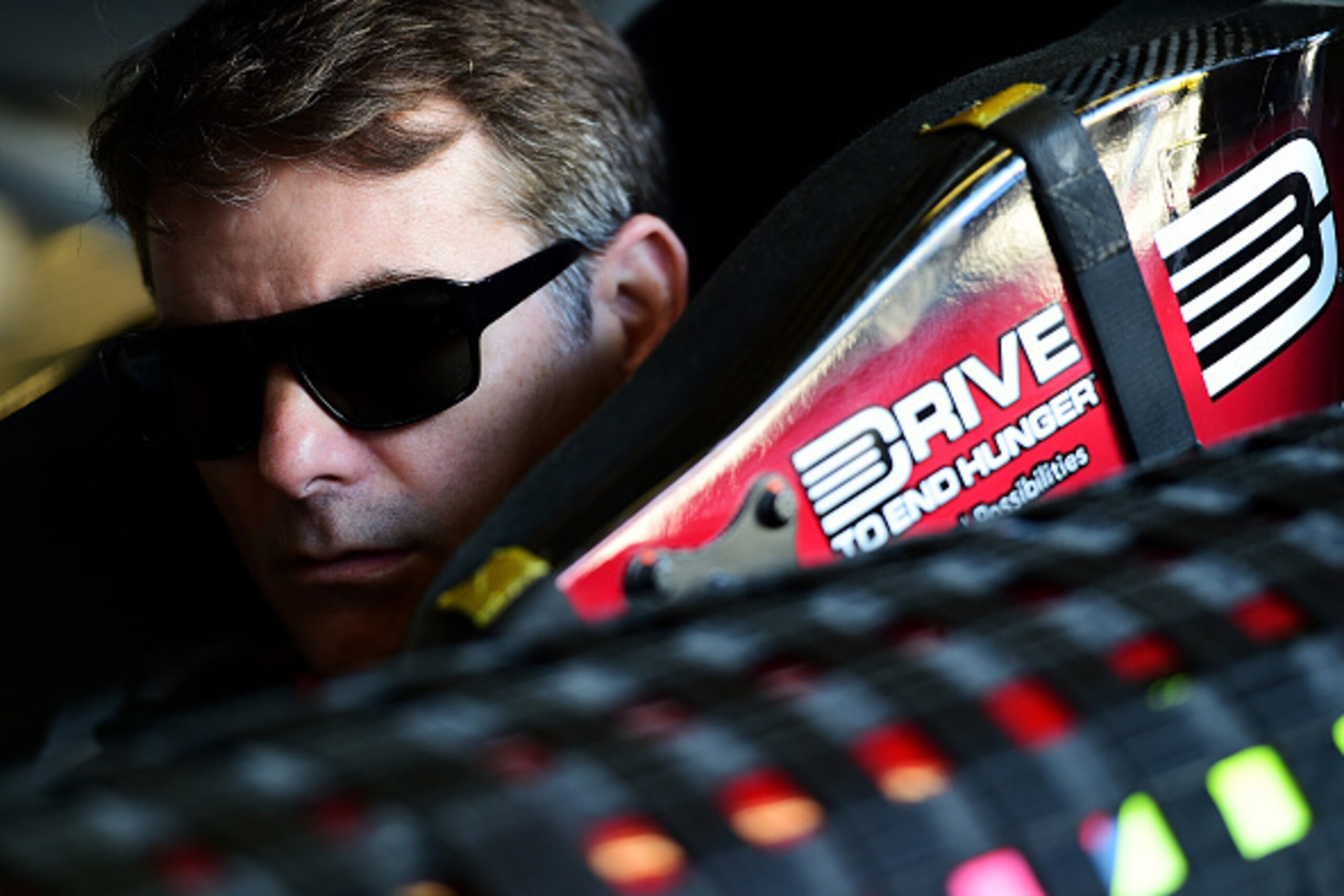 DAYTONA BEACH, FL - FEBRUARY 20:  Jeff Gordon, driver of the #24 Drive To End Hunger Chevrolet, sits in his car in the garage area during practice for the NASCAR Sprint Cup Series 57th Annual Daytona 500 at Daytona International Speedway on February 20, 2