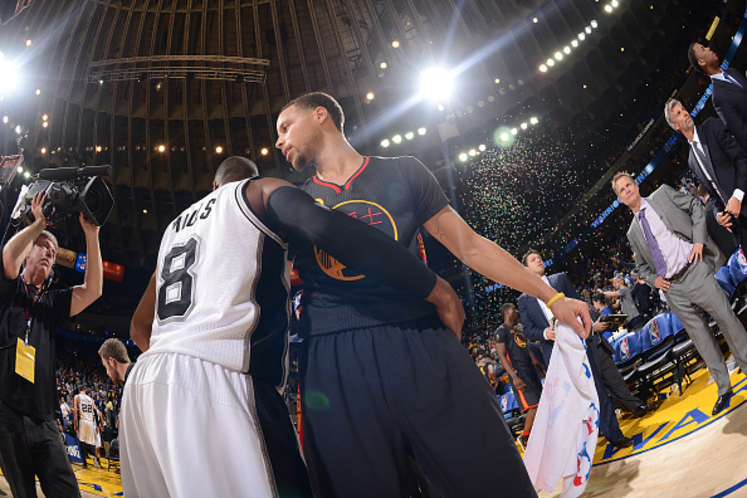 OAKLAND, CA - FEBRUARY 20: Stephen Curry #30 of the Golden State Warriors speaks with Patty Mills #8 of the San Antonio Spurs after the game on February 20, 2015 at Oracle Arena in Oakland, California. NOTE TO USER: User expressly acknowledges and agrees 