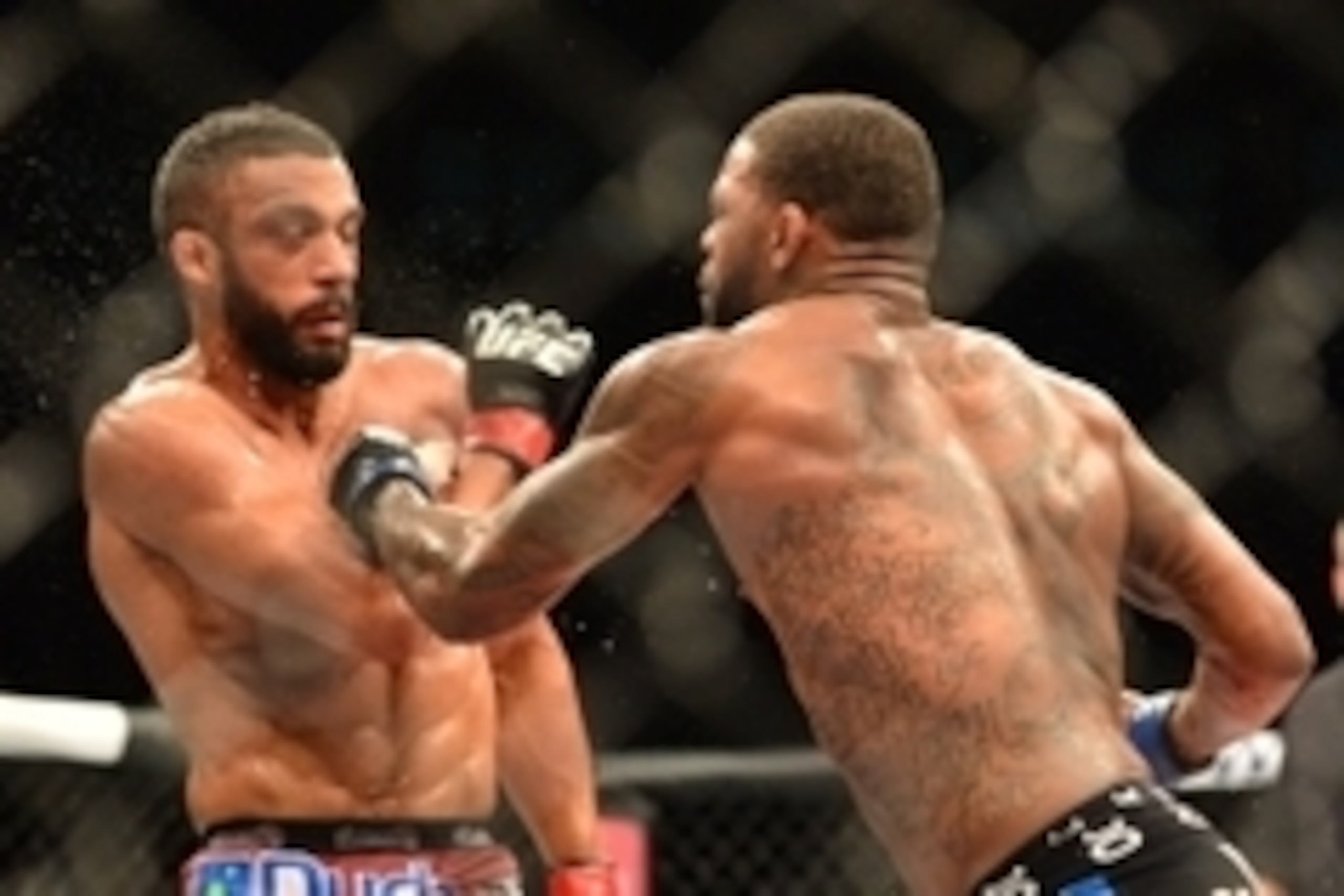 Feb 22, 2015; Porto Alegre, Brazil; Michael Johnson (blue gloves) fights against Edson Barboza (red gloves) during UFC Fight Night at Ginasio do Gigantinho. Mandatory Credit: Jason da Silva-USA TODAY Sports