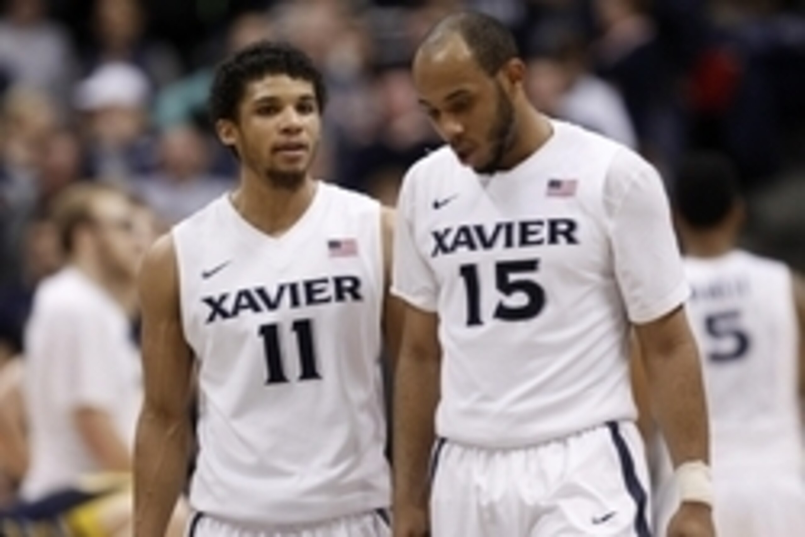 Jan 17, 2015; Cincinnati, OH, USA; Xavier Musketeers guard Dee Davis (11) and guard Myles Davis (15) talk during the second half against the Marquette Golden Eagles at the Cintas Center. Xavier won 62-58. Mandatory Credit: Frank Victores-USA TODAY Sports