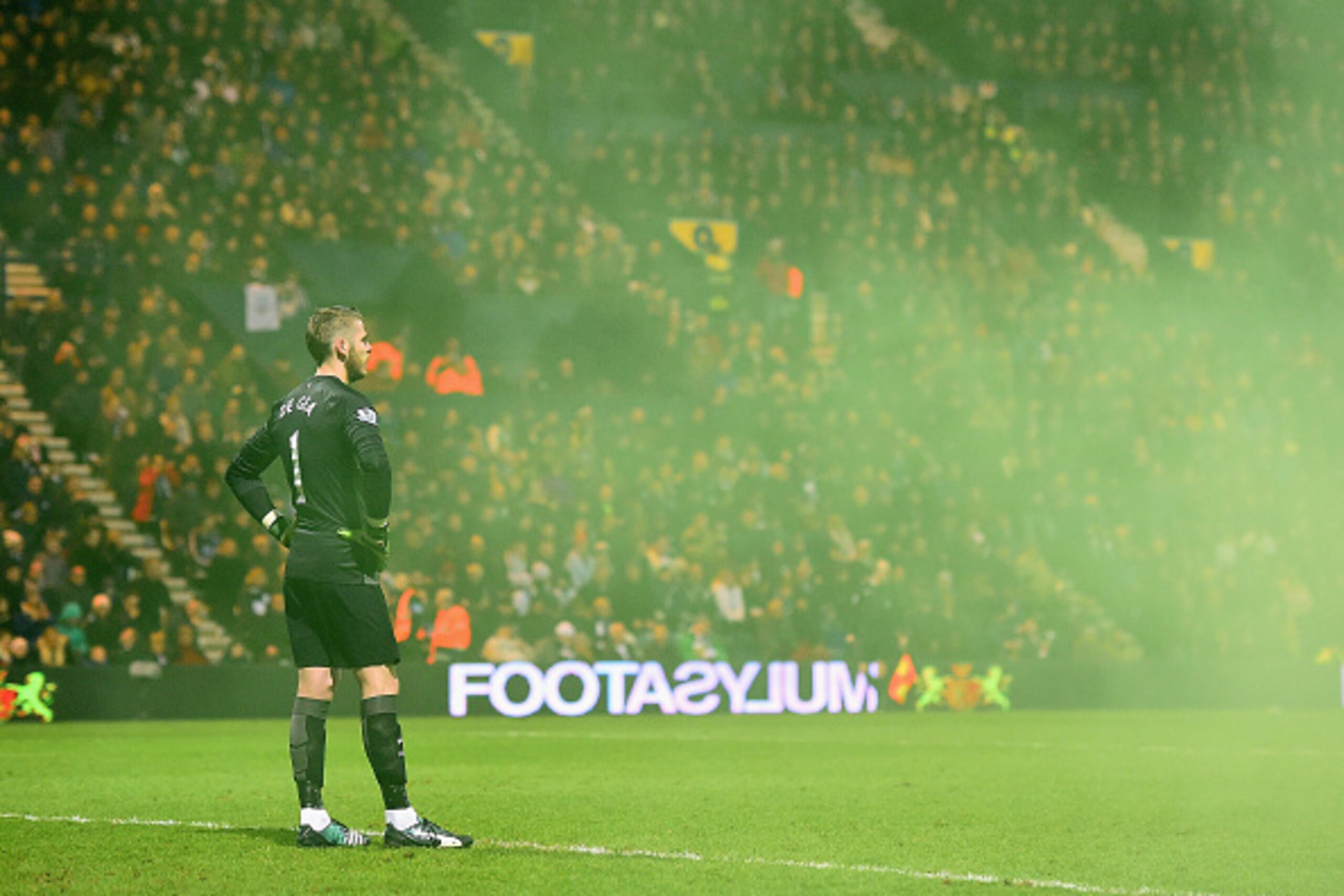 PRESTON, ENGLAND - FEBRUARY 16:  David De Gea of Manchester United looks on through smoke from a flare during the FA Cup Fifth round match between Preston North End and Manchester United at Deepdale on February 16, 2015 in Preston, England.  (Photo by Lau