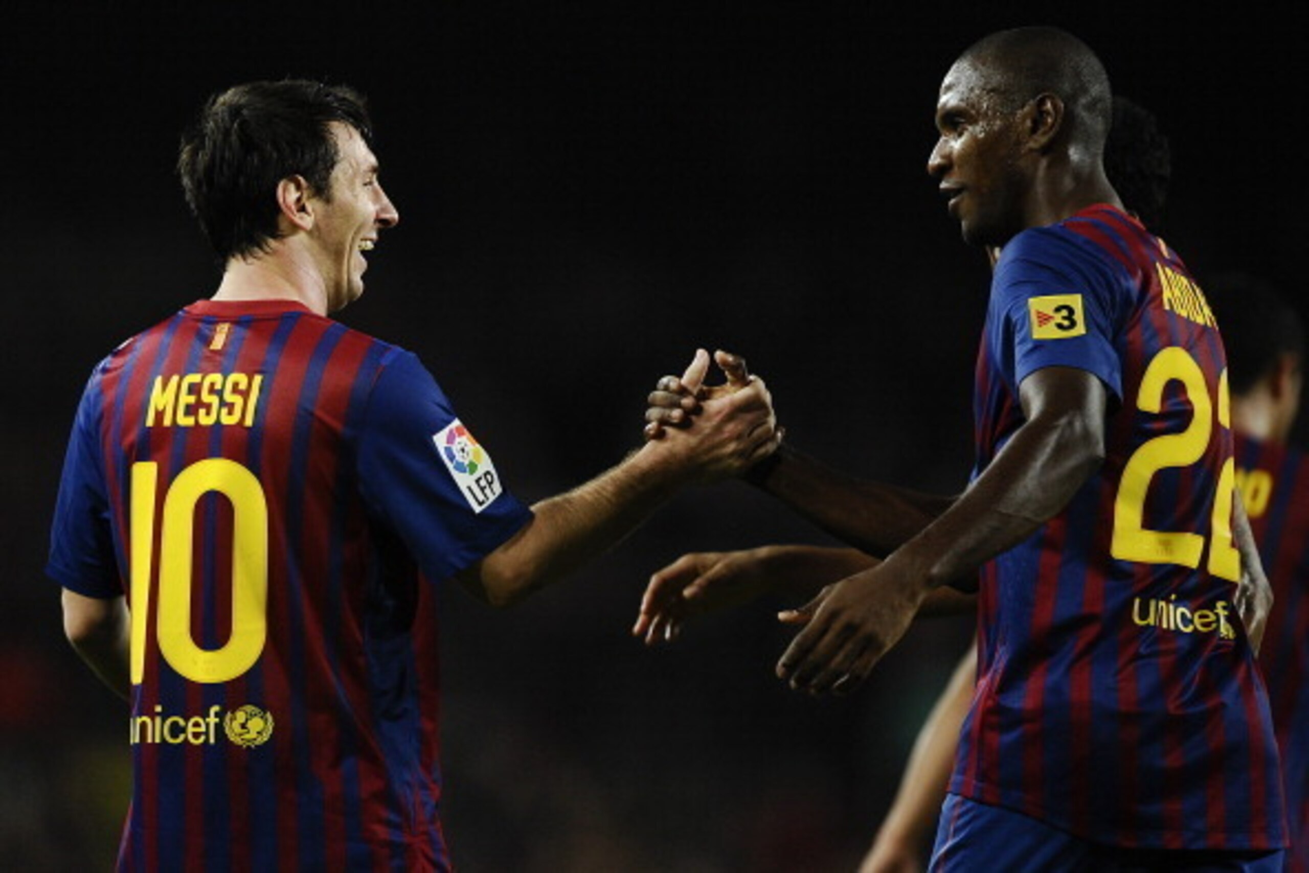 BARCELONA, SPAIN - OCTOBER 29:  Lionel Messi of FC Barcelona (L) celebrates with his teammate Eric Abidal of FC Barcelona after scoring his third team's goal during the La Lliga match between FC Barcelona and RCD mallorca at Camp Nou on October 29, 2011 i