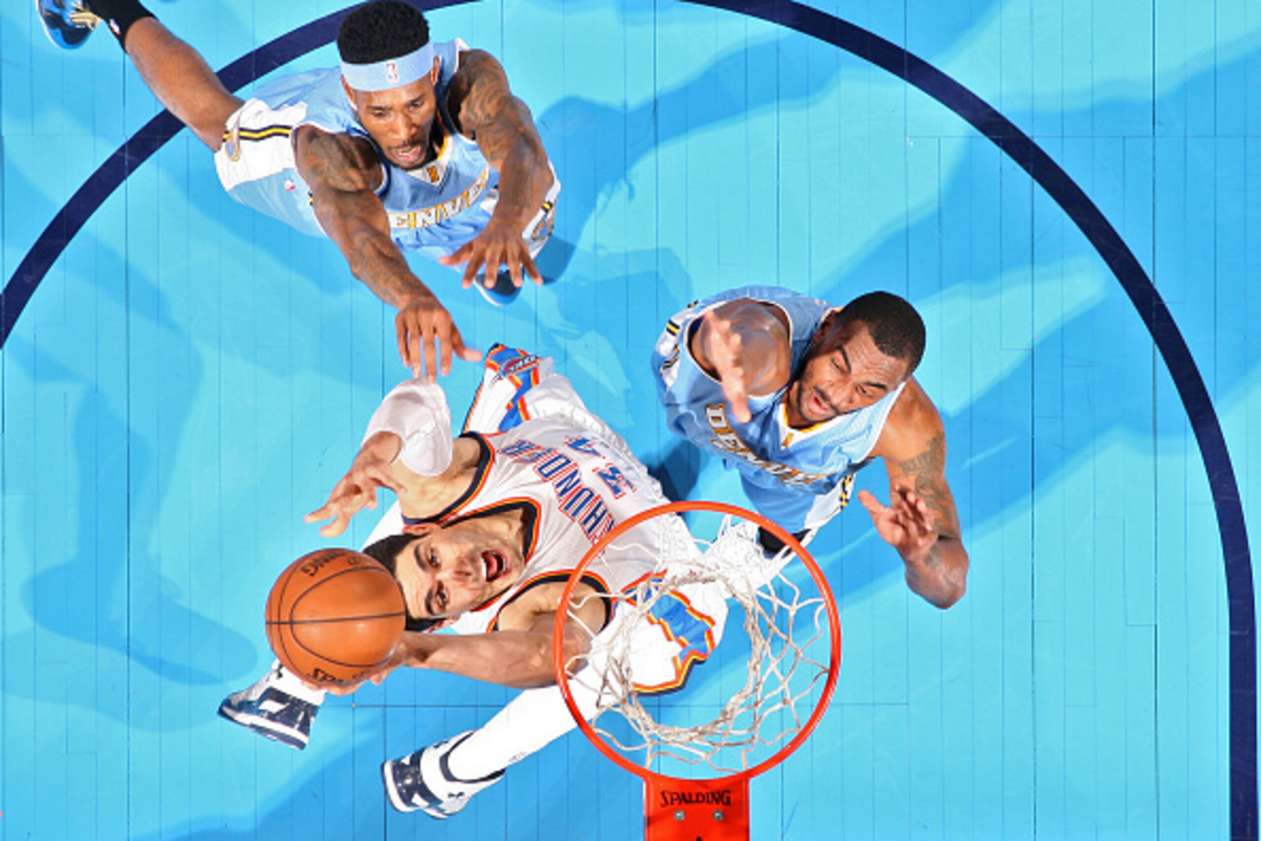 OKLAHOMA CITY, OK - FEBRUARY 22:  Enes Kanter #34 of the Oklahoma City Thunder goes to the basket against the Denver Nuggets on February 22, 2015 at the Chesapeake Energy Arena in Oklahoma City, Oklahoma. NOTE TO USER: User expressly acknowledges and agre