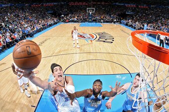 OKLAHOMA CITY, OK - FEBRUARY 22:  Enes Kanter #34 of the Oklahoma City Thunder goes to the basket against the Denver Nuggets on February 22, 2015 at the Chesapeake Energy Arena in Oklahoma City, Oklahoma. NOTE TO USER: User expressly acknowledges and agre